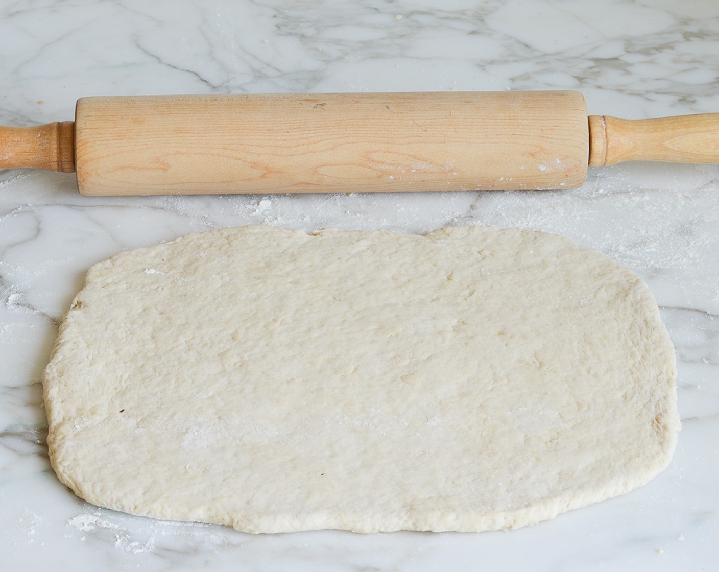 step 7 Lightly dust the surface again. Pat the dough into a small rectangle, then roll into a 12-inch x 9-inch rectangle, dusting more flour sparingly if necessary so the dough doesn't stick to the rolling pin.