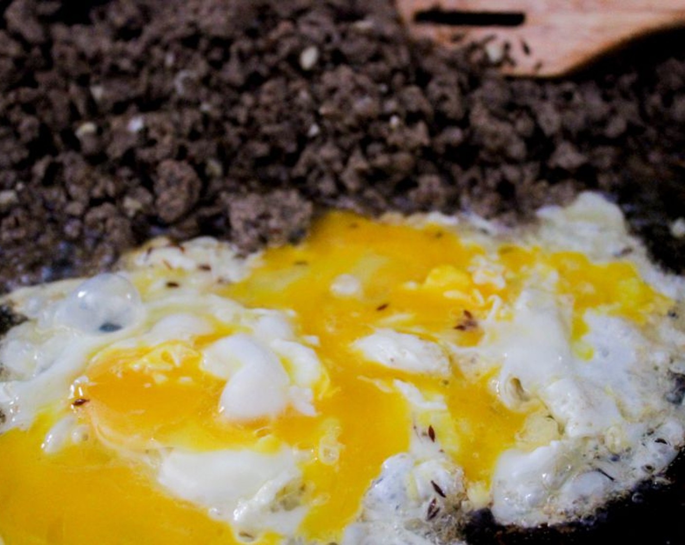 step 7 Add Eggs (2) into the pan and let it cook for a little before mixing it in with the beef, approximately 30 seconds, Then break the yolks and swirl the egg around and mix it with the beef and cook for an additional 3 mins.