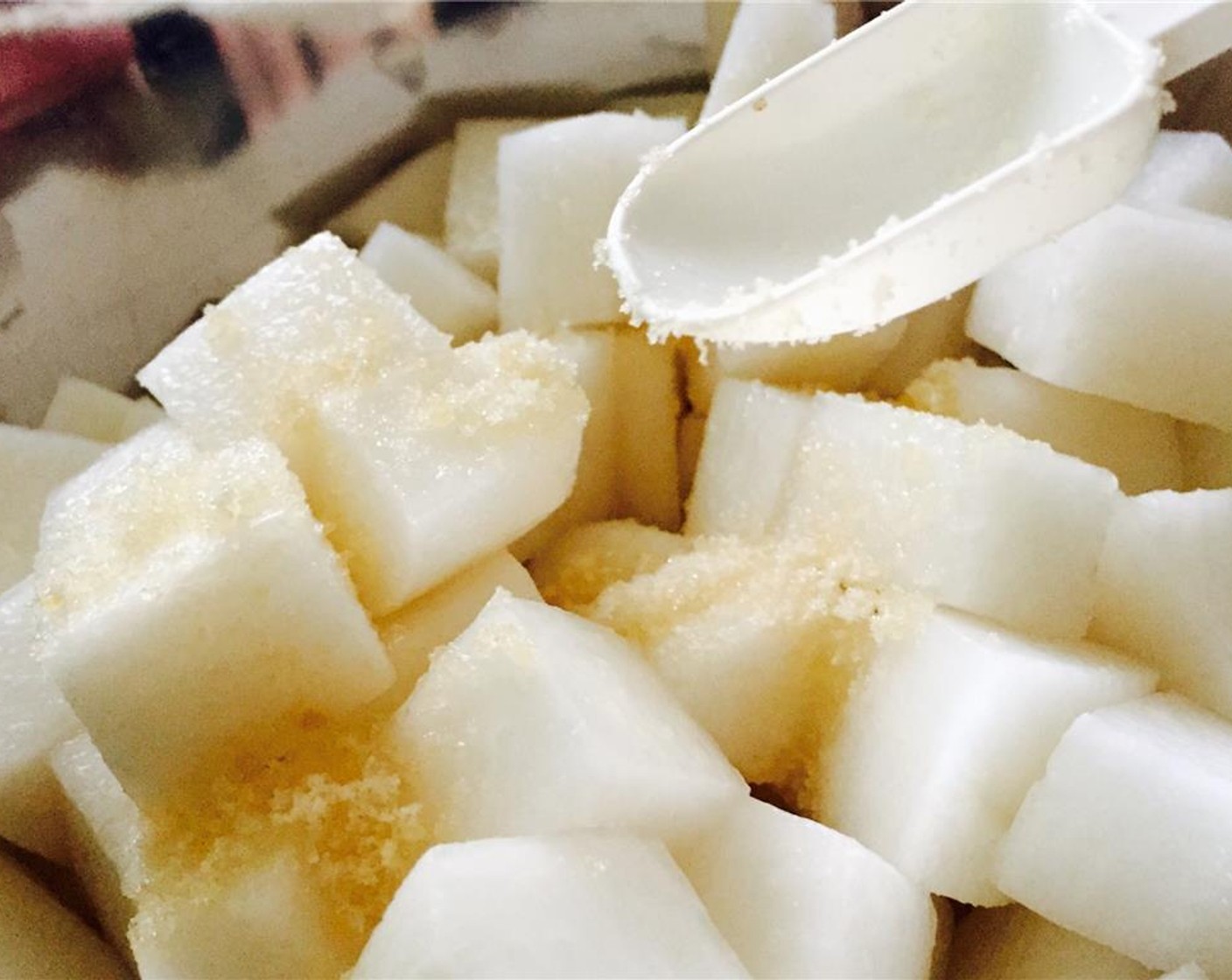 step 4 Put white radish in a large mixing bowl and sprinkle Granulated Sugar (1 Tbsp) over it.