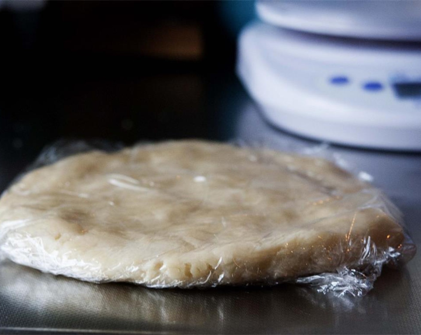 step 5 Flatten the dough into a round shape and wrap it in plastic wrap. Place it in your freezer for about 30 minutes.