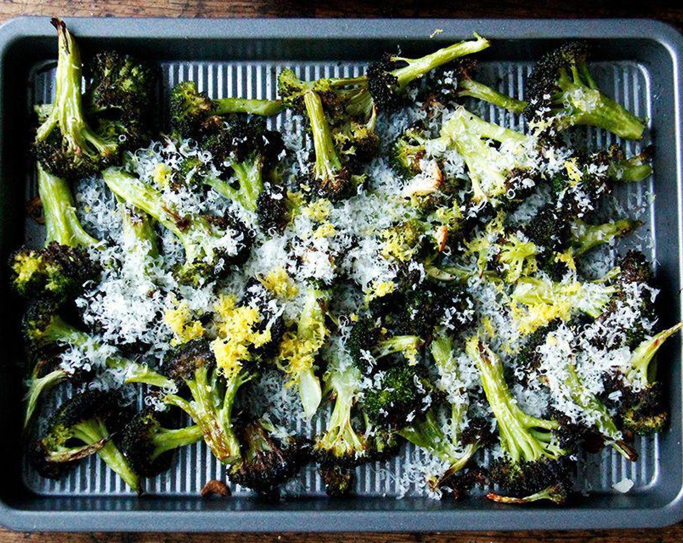 step 5 Remove the broccoli from the oven and immediately toss with the zest and juice of the Lemon (1) and the Parmesan Cheese (to taste).