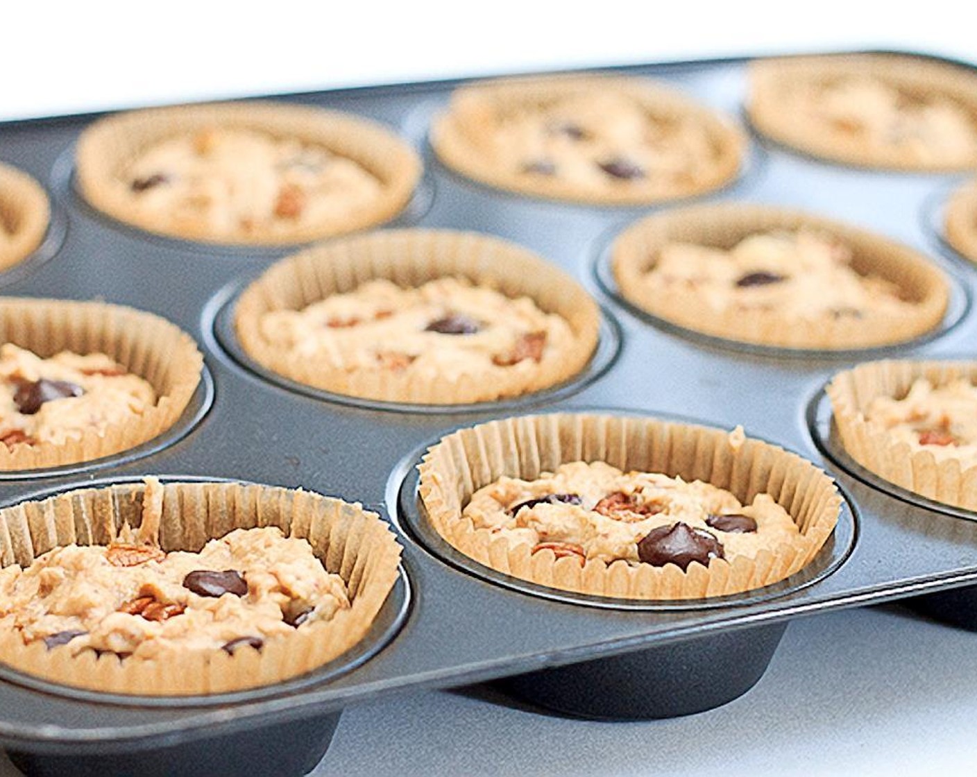 step 7 Fill paper-lined muffin cups two-thirds full. Bake for 25 minutes or until a toothpick comes out clean.