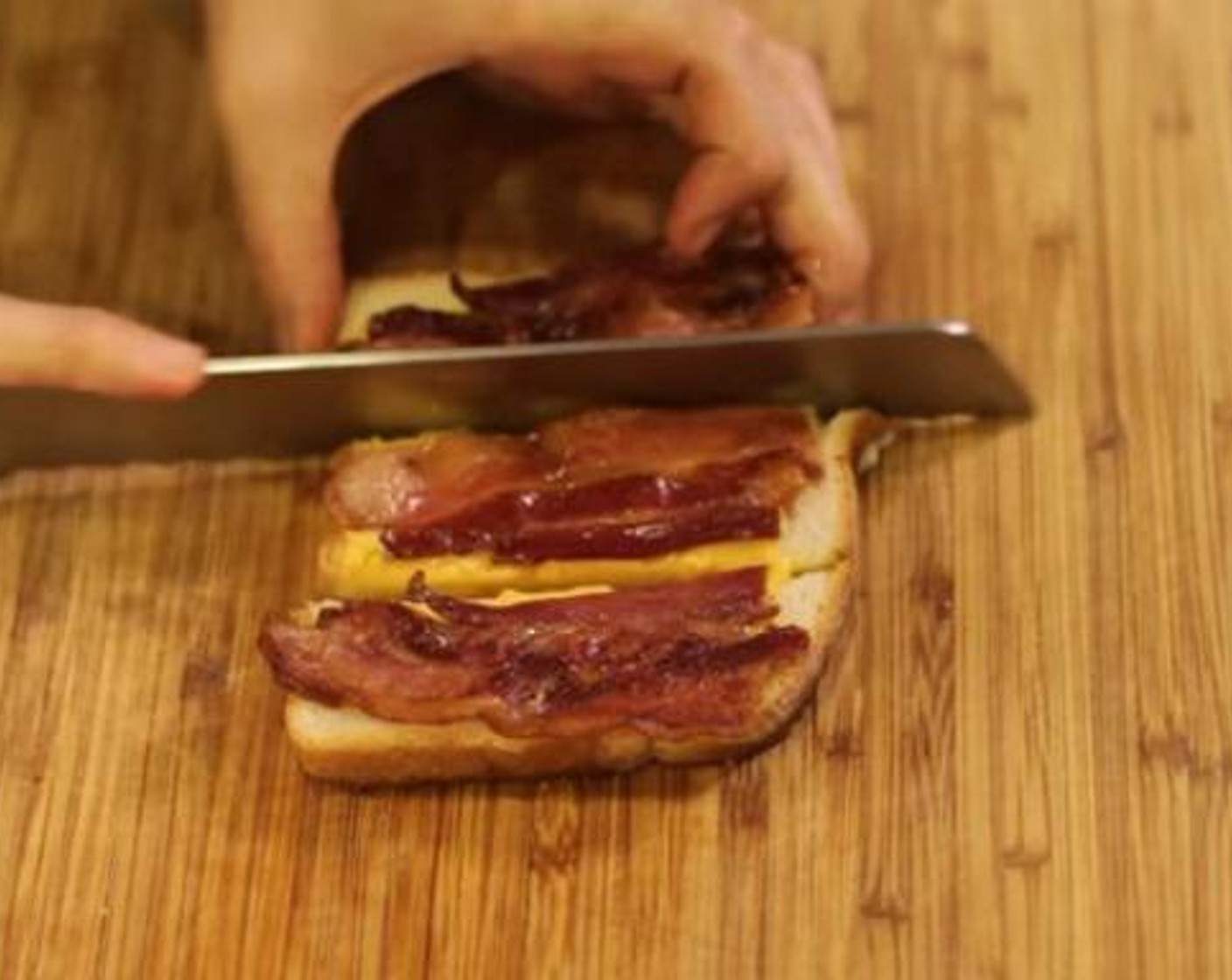 step 5 Take the bread off of the grill onto a cutting board and cut into three strips using the bacon as a guide.