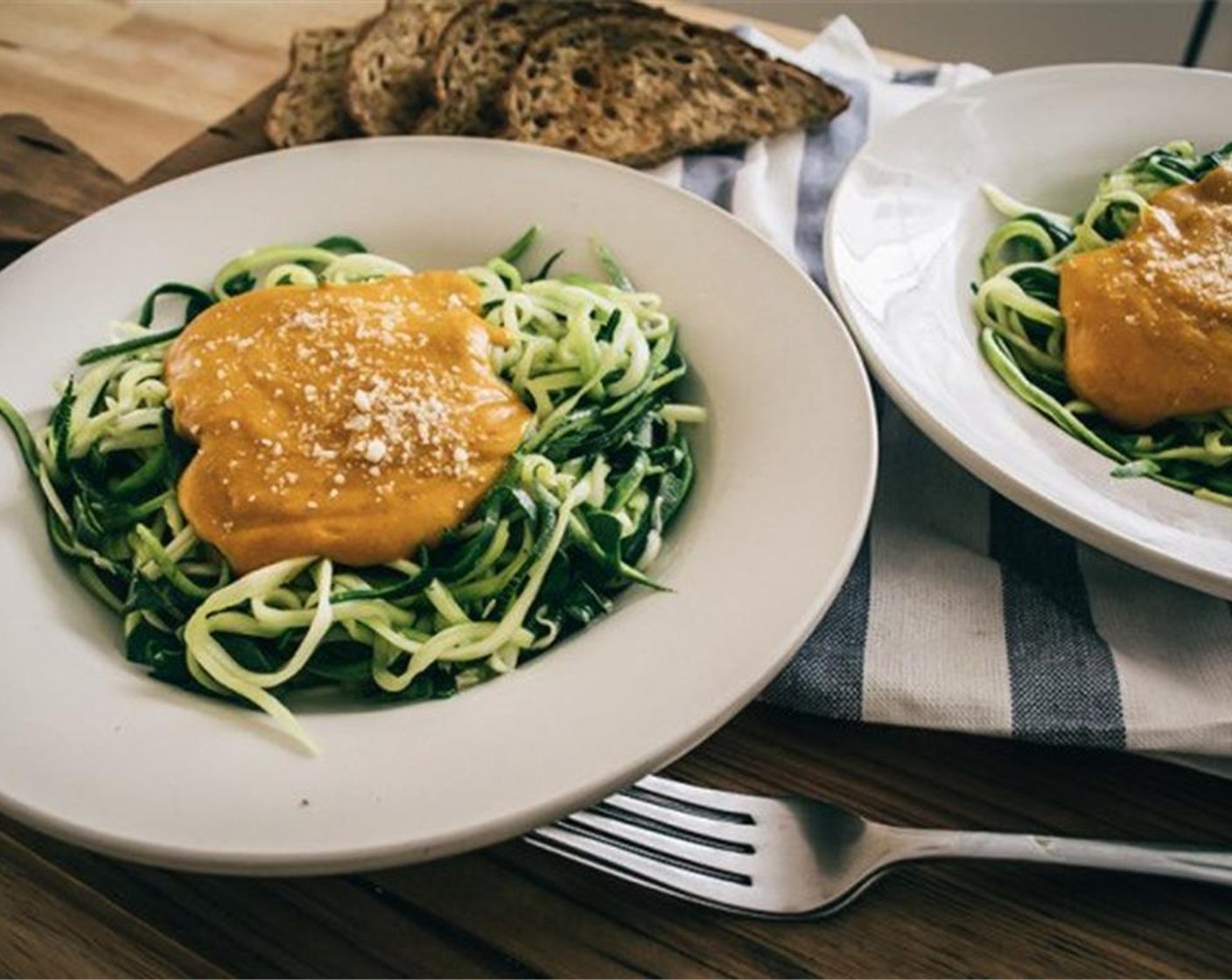 step 8 Drain water from cooked veggies, then split into two pasta dishes and top with pumpkin alfredo sauce, sprinkle with Parmesan Cheese (to taste) and serve!