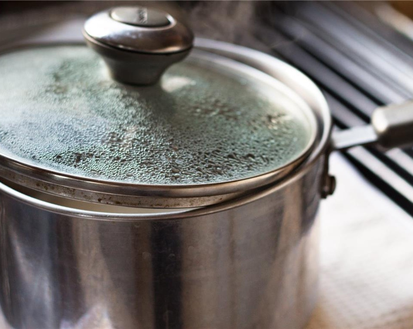 step 5 About 20 minutes before the adobo is ready, add the White Rice (2 cups) into a medium pot with Water (4 cups). Add two pinches of Salt (to taste). Bring to a boil over medium heat with the lid off.