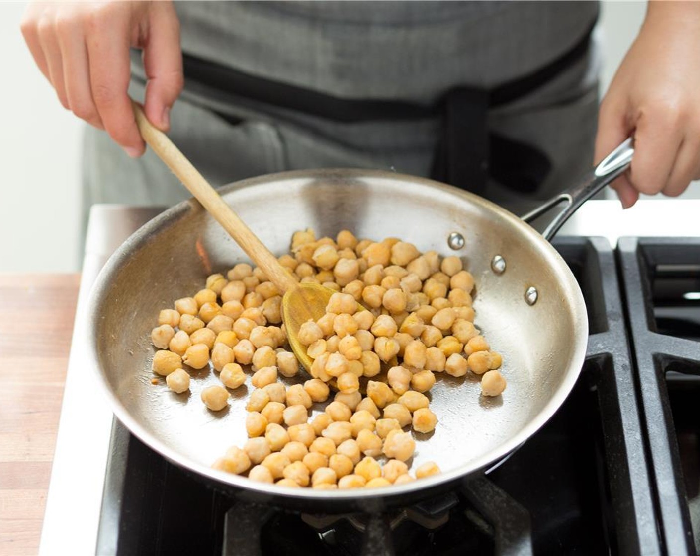 step 8 When hot, add the chickpeas and saute for six minutes, or until golden brown.