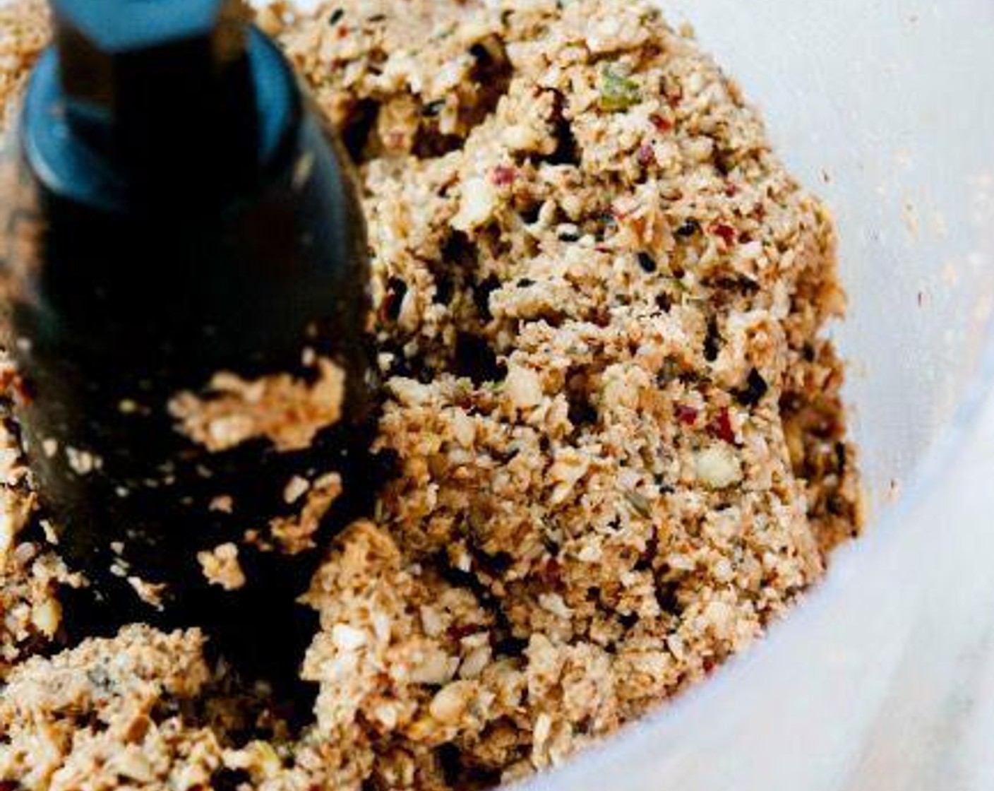 step 2 Place the soaked ingredients, Black Sesame Seeds (1 tsp), White Sesame Seeds (1 tsp), Unsweetened Shredded Coconut (1 cup), Simply Organic Cinnamon, Ground (1/4 tsp), Cacao Powder (1/2 tsp), and Maple Syrup (2 Tbsp) into a food processor and blend until a paste forms.