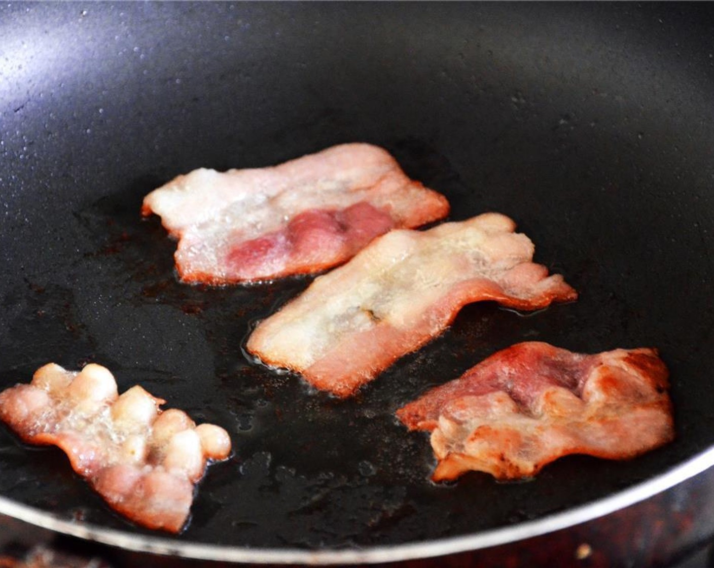 step 1 Cook the Bacon (2 slices) over medium heat in a skillet until crispy, flipping halfway through cooking.