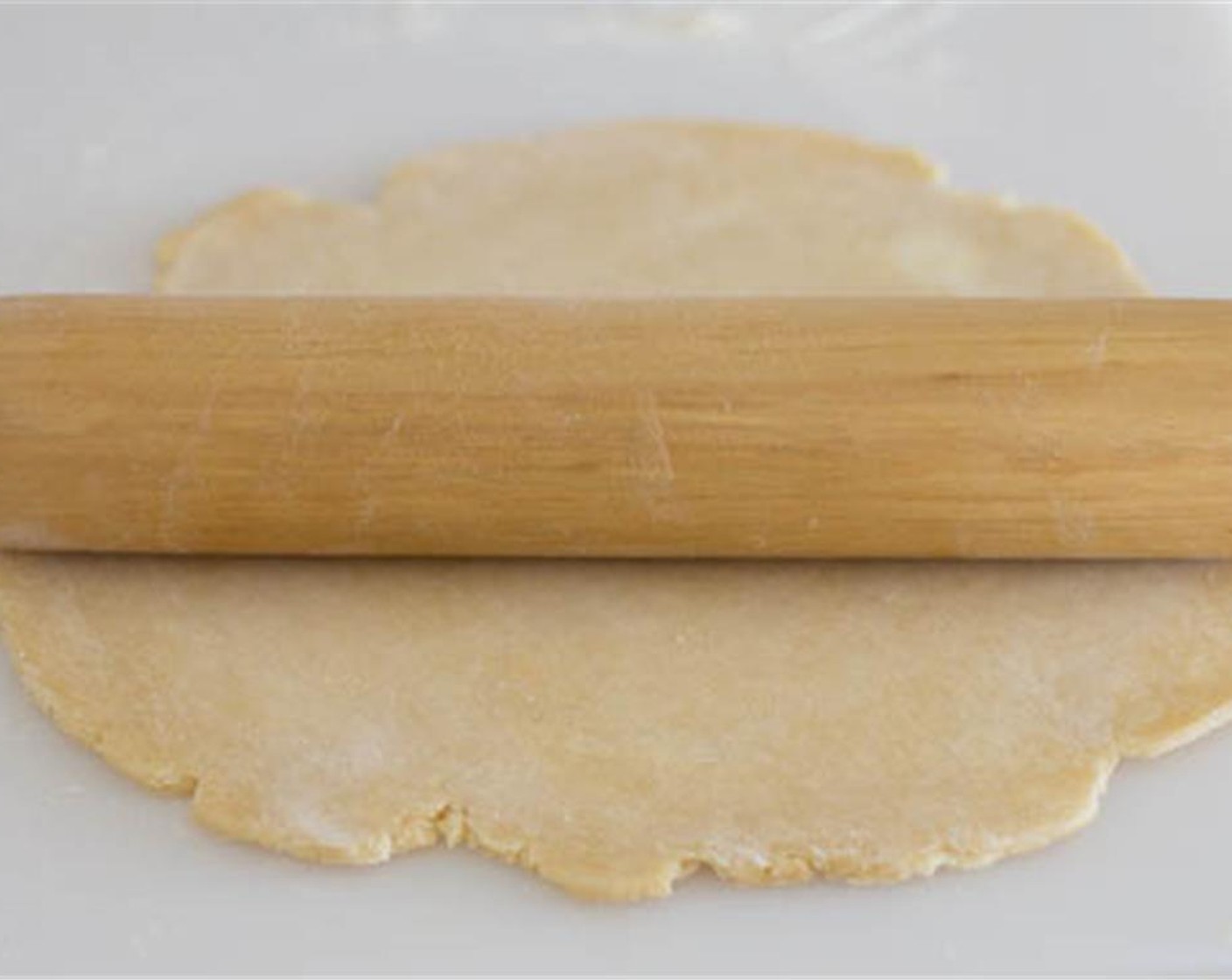 step 2 On a floured surface, roll the Pie Crust (1) into a 10-inch circle. Place the dough on 9-inch quiche pan, cut the excess dough and pierce with fork everywhere. Place aluminum foil over the pie crust and add dried beans or rice.