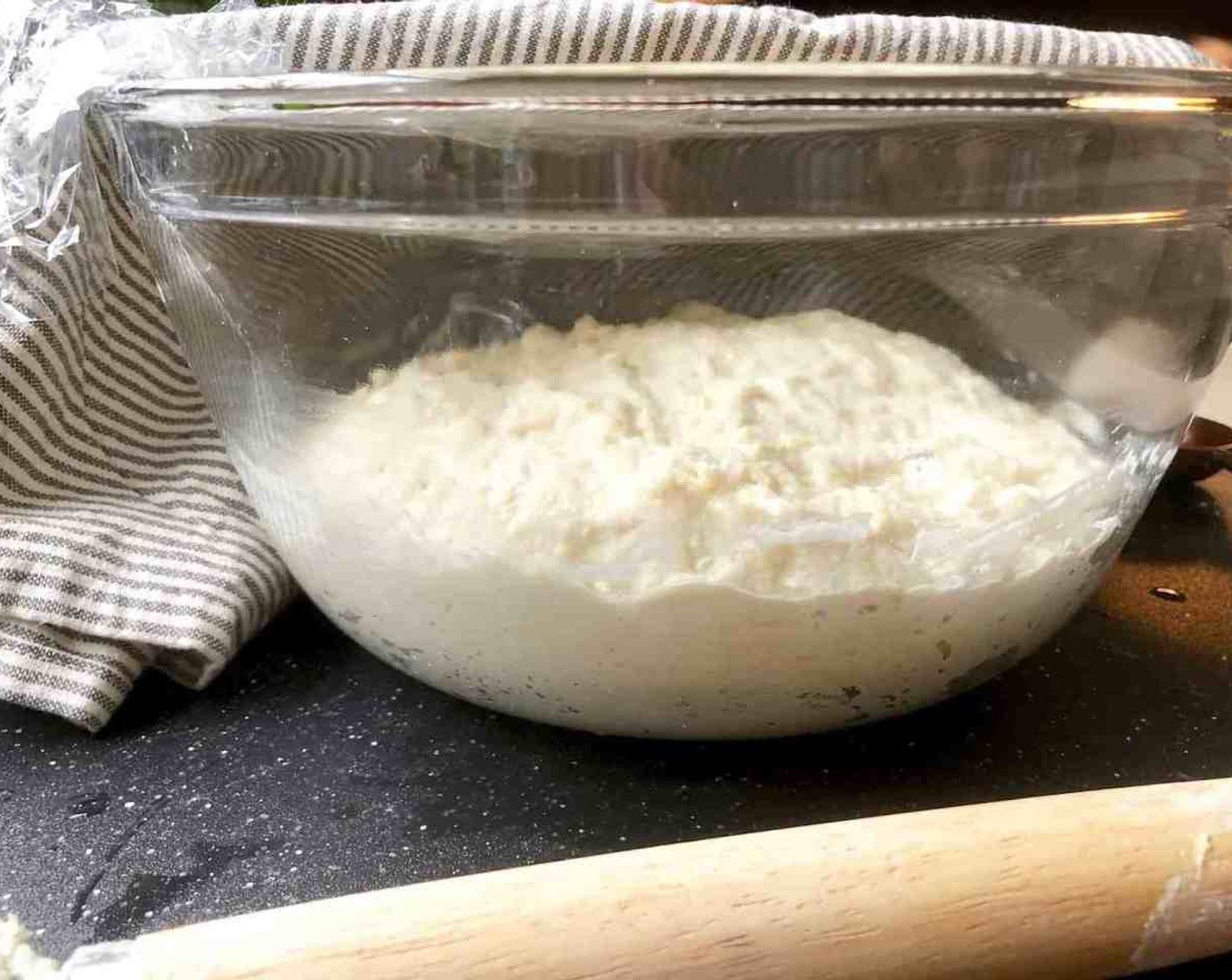 step 4 Loosely cover the container and let the dough hang out at room temperature until it begins to rise considerably. It will collapse or flatten a little on the top in about 2 hours.