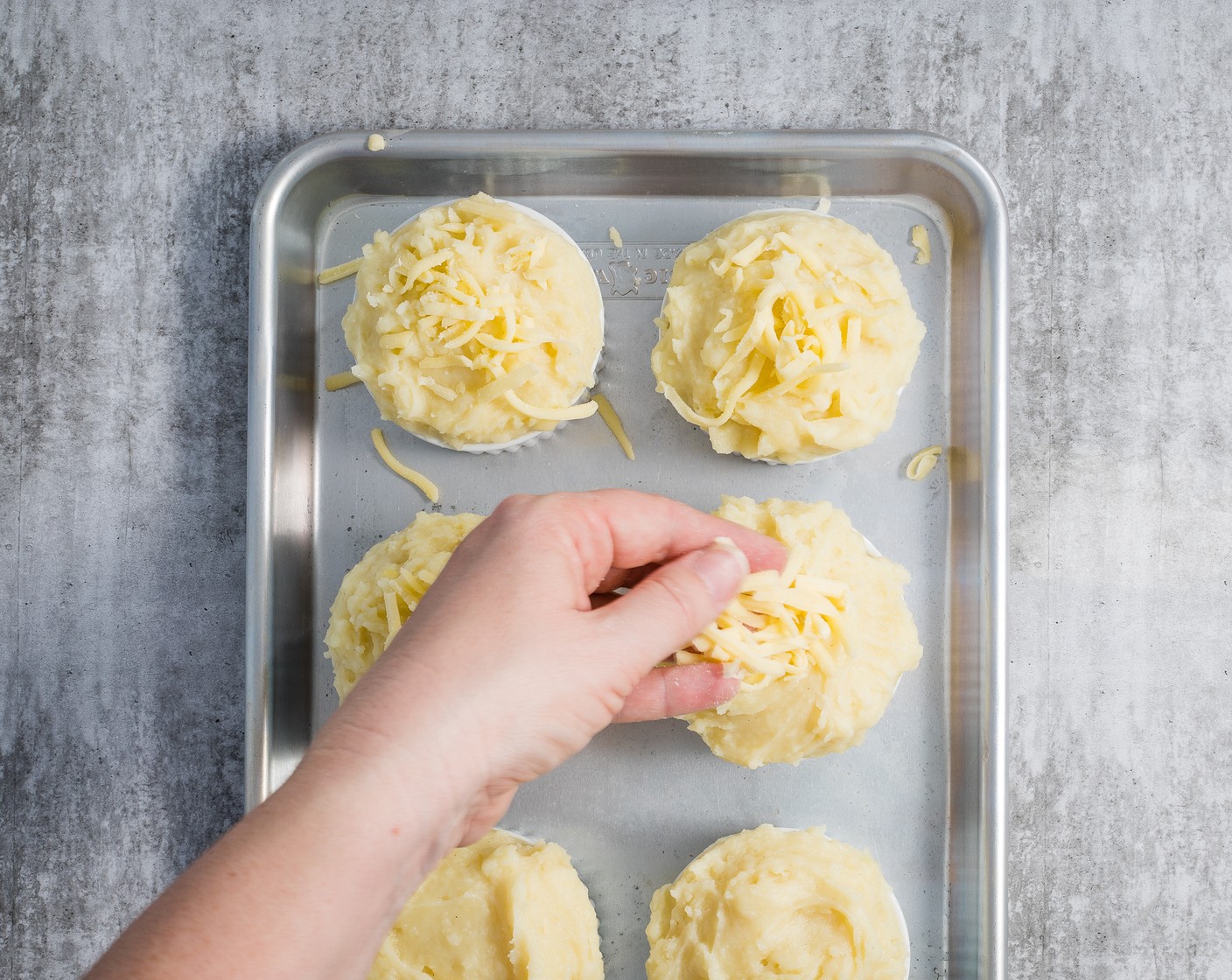 step 6 Fill the prepared dish/es with turkey filling. Give the Mashed Potatoes (2 cups) a stir and loosen with a little extra Milk (as needed) if they aren’t a spreadable consistency. Spread the mash over the pie/s, then top with Shredded Cheese (1 cup).