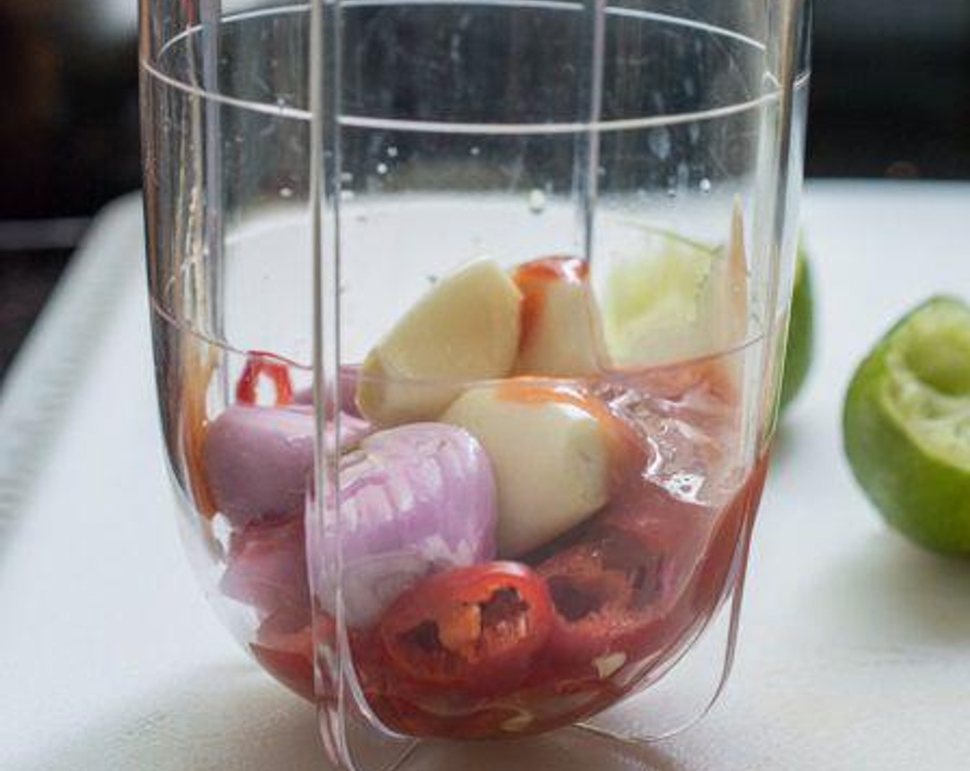 step 3 A few minutes before the potatoes are done, prepare the sambal sauce: Put Red Chili Peppers (2), Garlic (3 cloves), Shallots (3), the pale part of the Lemongrass (1 stalk), Ketchup (1 Tbsp), juice from the Lime (1/2) and Water (1/4 cup) in a food processor or Magic Bullet and blend till smooth.