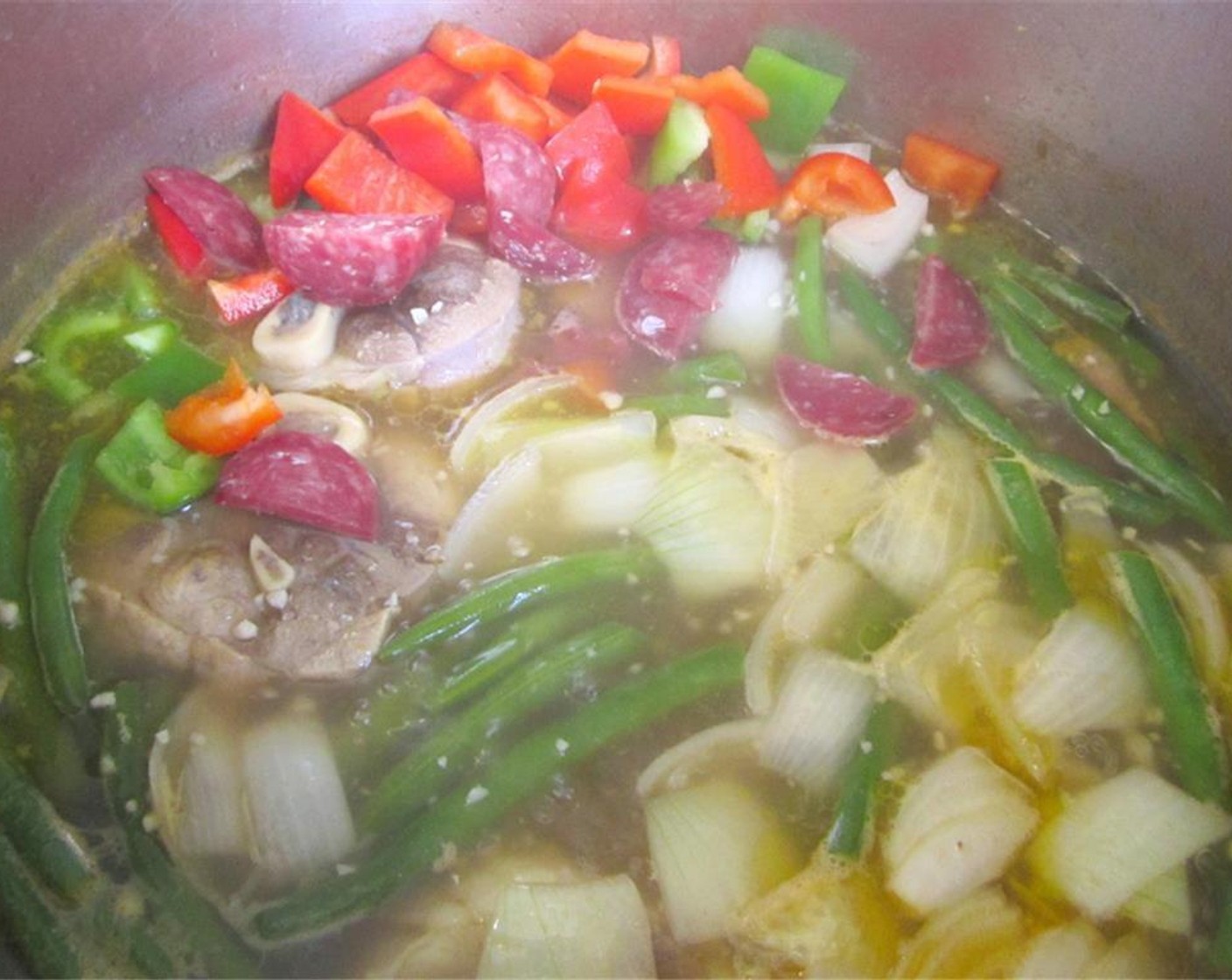 step 4 Add diced Bell Peppers (2 cups), diced Onions (2 cups) and Chinese Sausages (2). Simmer two more minutes, check and adjust seasoning.
