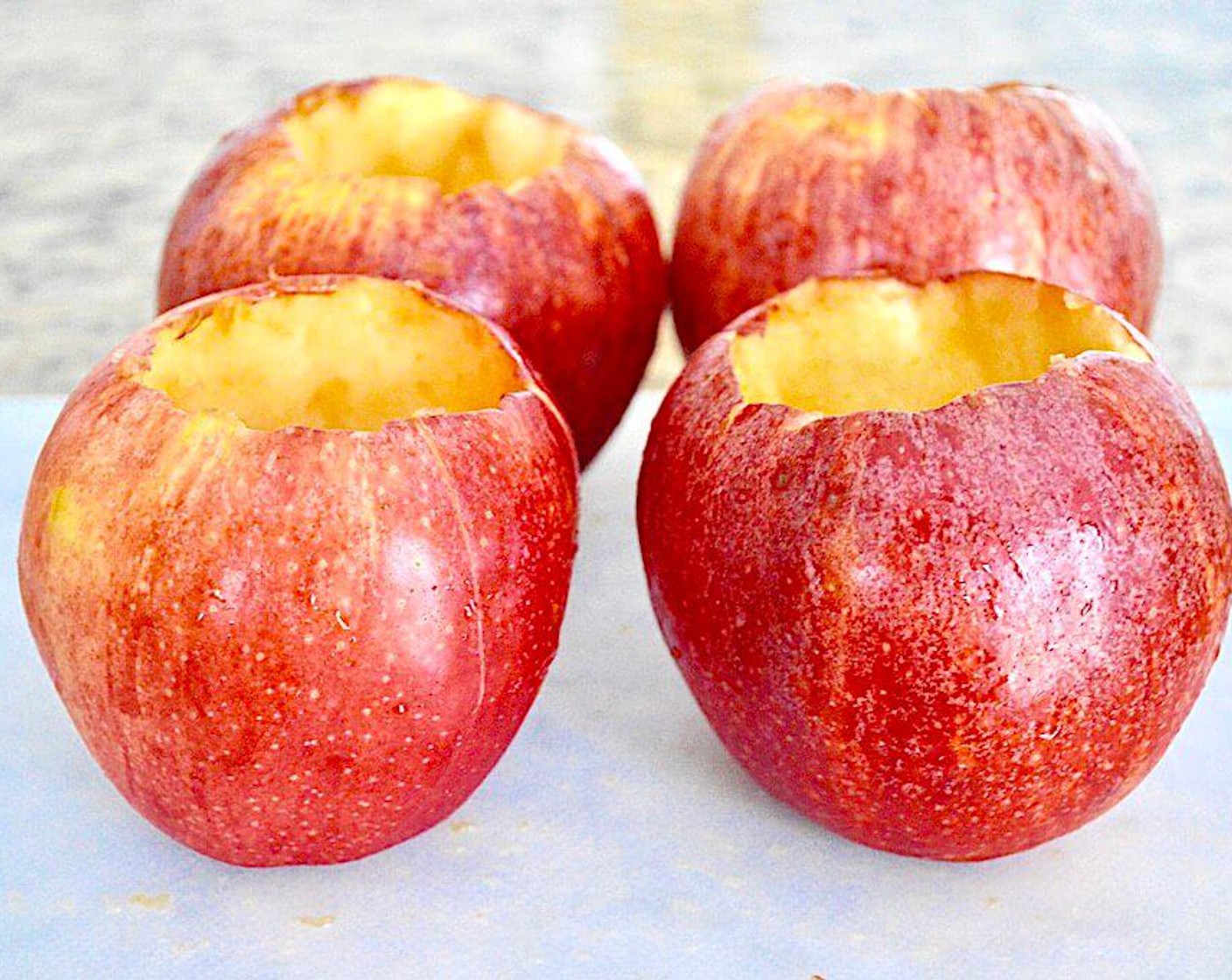 step 1 Preheat the oven to 375 degrees F (190 degrees C) and get out an 8 x 8 baking dish. Then rinse and dry the Apples (4) thoroughly. Use a paring knife to cut out the cores of the apples and use a spoon to scoop out the seeds. Leave about 1/2 inch on the bottom of the apples for a sturdy foundation.