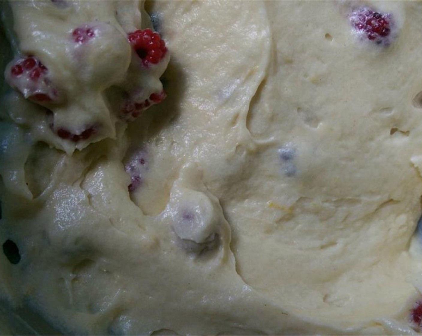 step 7 Once the dry and wet ingredients have been fully incorporated, carefully fold the berries into the lemon zest flecked batter. Pour the batter into the prepared pan.