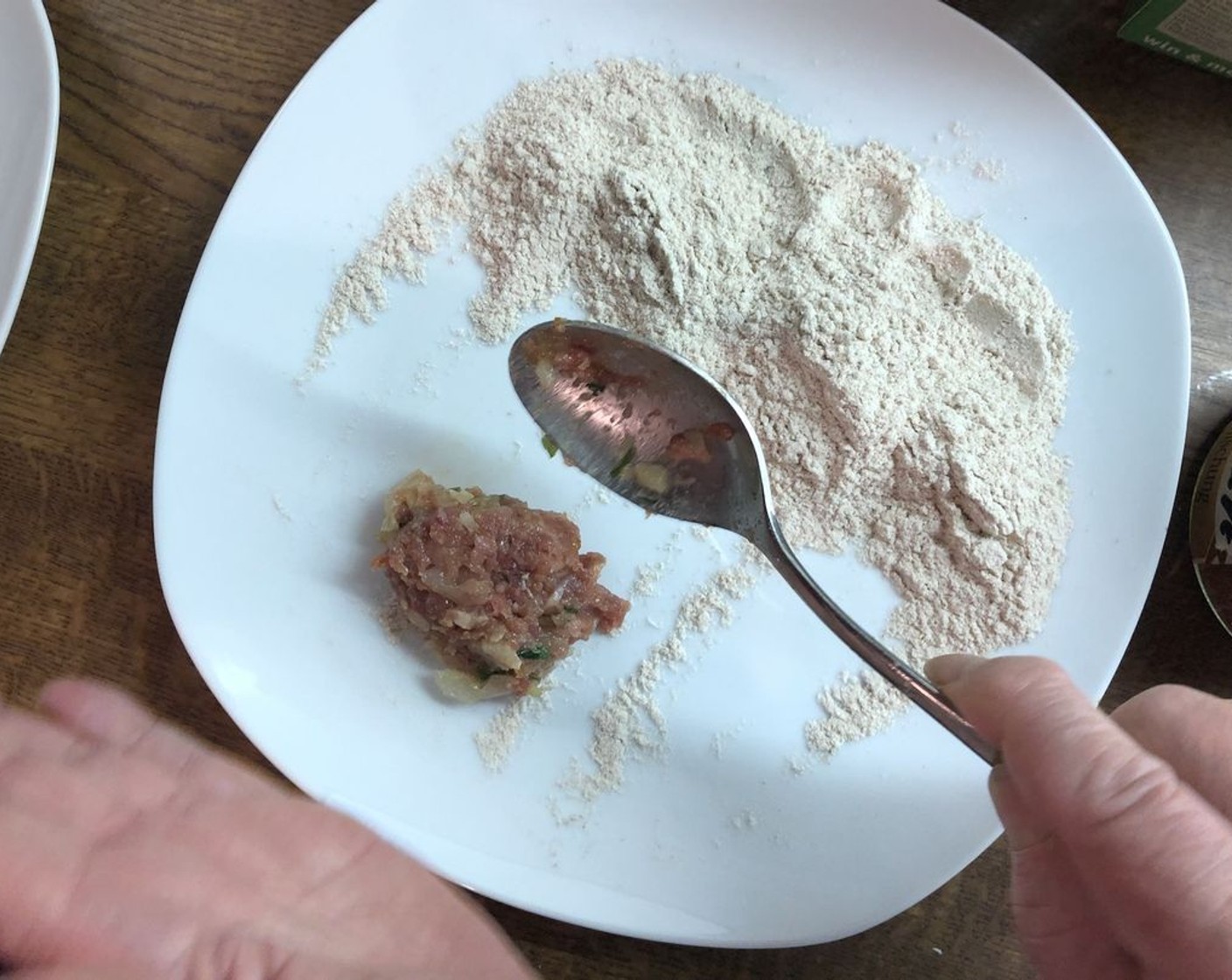 step 15 Using a tablespoon, scoop a small amount of the meat mixture on to the plate and coat lightly with flour.