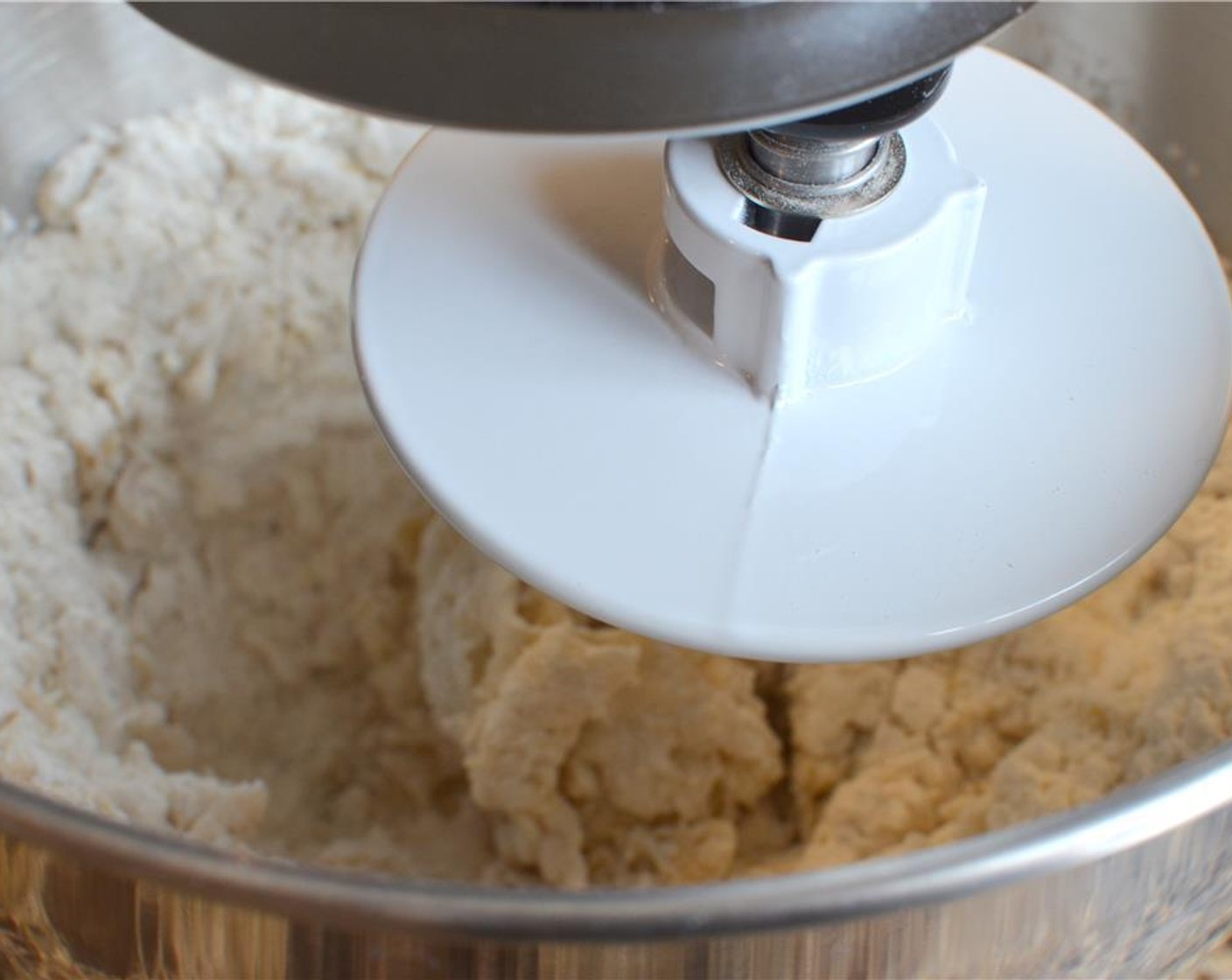 step 4 Add all the flour to the yeast mixture and with the dough hook attachment, turn the mixer to medium speed until a smooth and elastic ball forms (about 5-6 minutes).