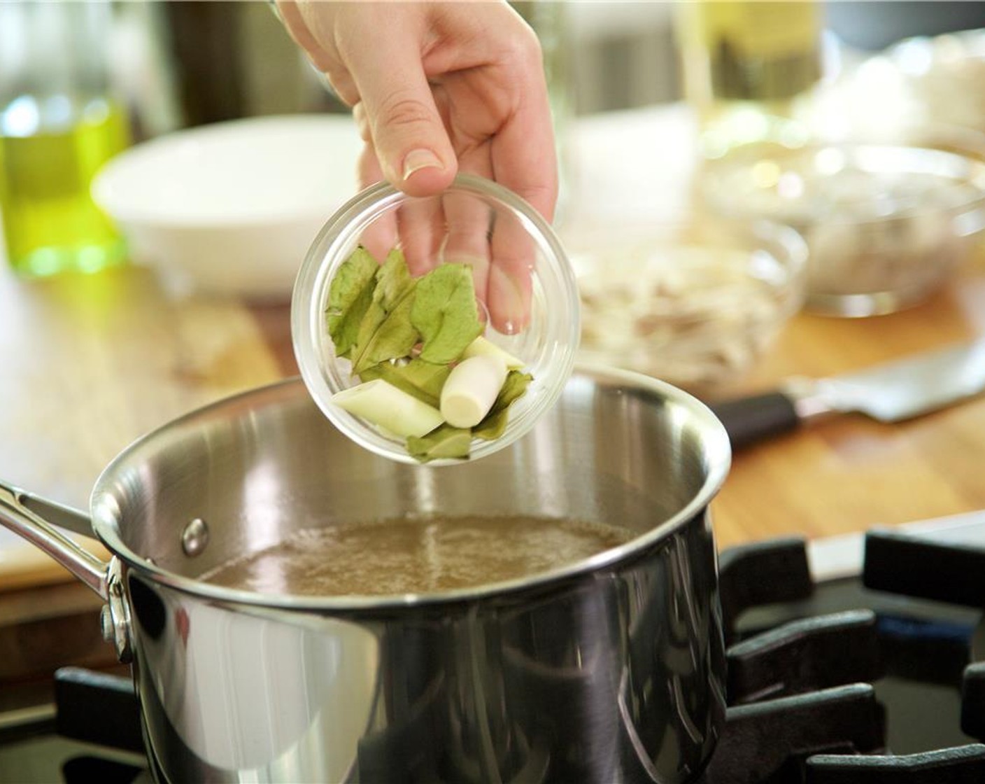 step 8 In a medium saucepan, heat Chicken Base (2 pckg) and four cups of water over high heat. When the broth is about to boil, add lemongrass and Kaffir Lime Leaf (1 pckg). All it to come to a boil.