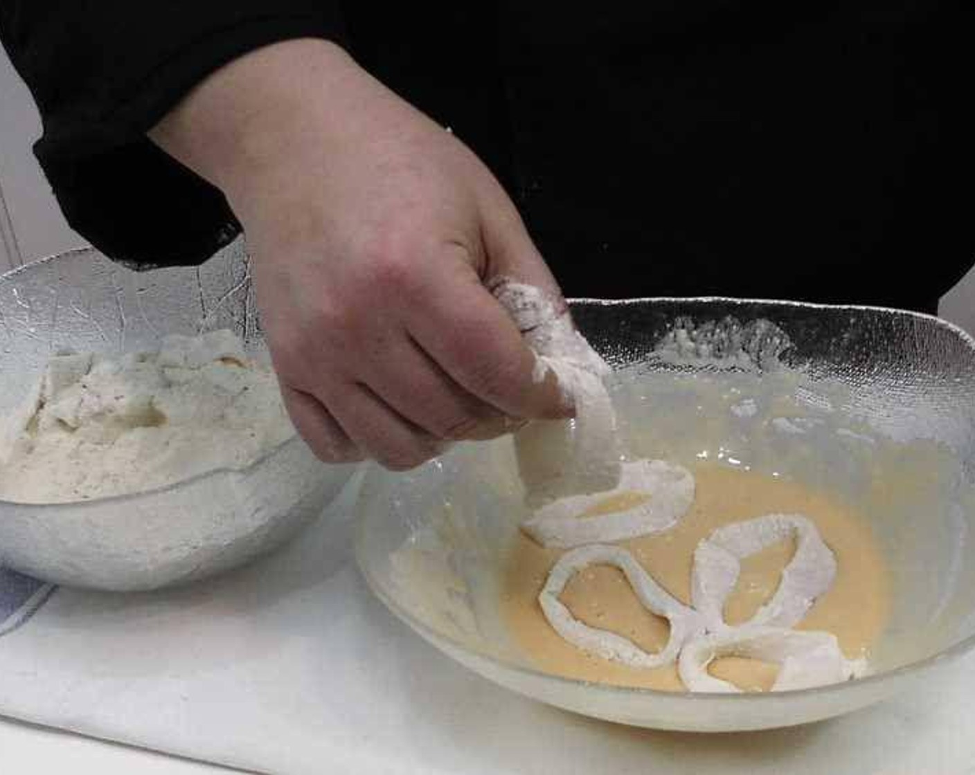 step 4 In another bowl add in All-Purpose Flour (to taste). Next take the Calamari (to taste) and season with Salt (to taste) then proceed to toss in the flour, then in the egg batter.