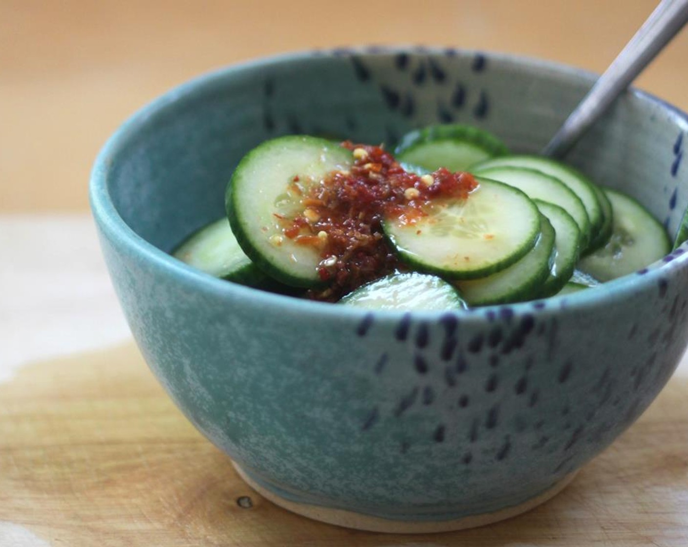 step 1 Pickle the cucumbers. In a large bowl whisk together the Sesame Oil (1 tsp), Rice Vinegar (1/4 cup), Distilled White Vinegar (1/4 cup), Honey (1 Tbsp), Sriracha (1 Tbsp). Add the English Cucumber (1) and let sit at least 30 minutes, but the longer the better.