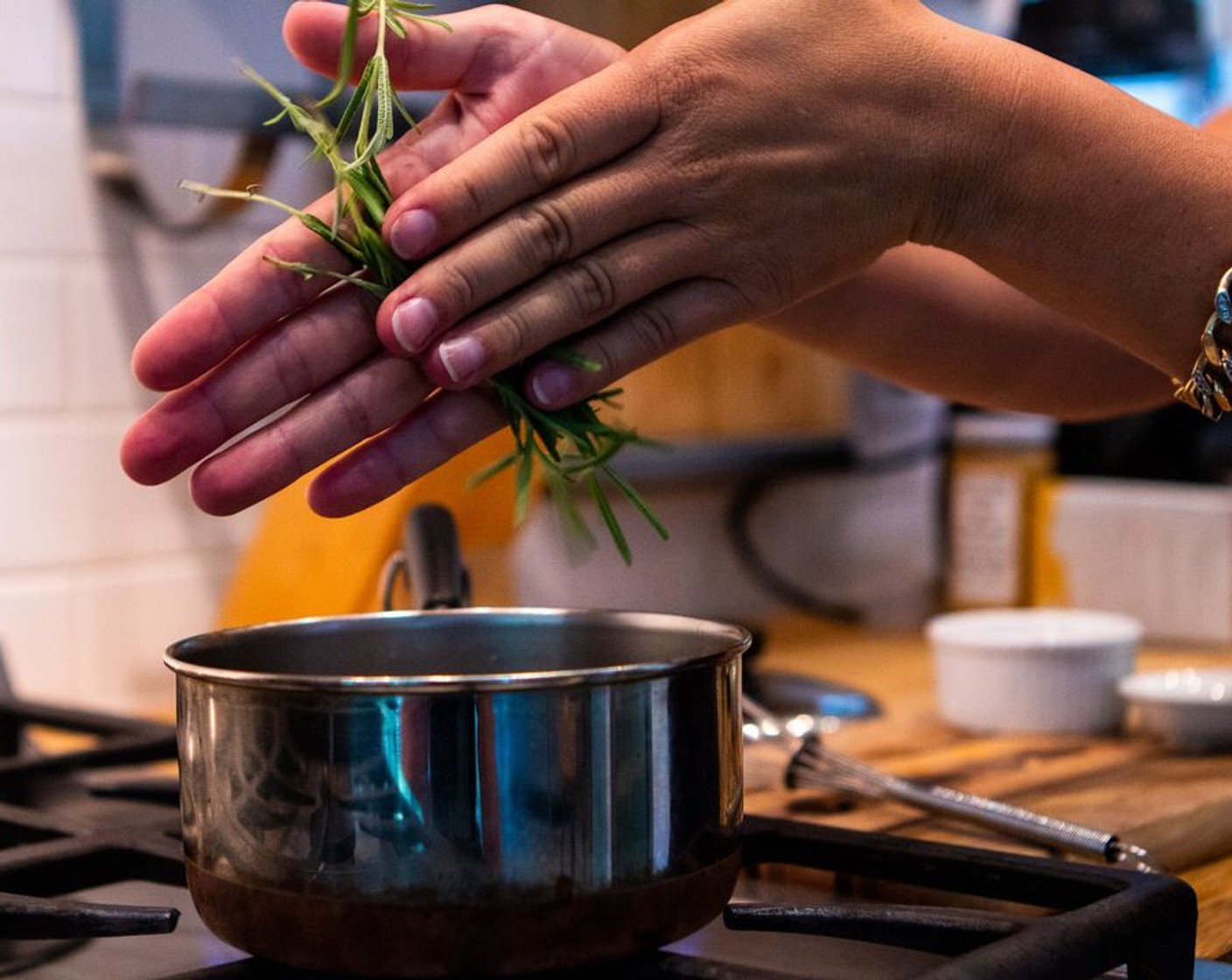 step 2 Gently roll the Fresh Rosemary (1 sprig) between your hands to release the essential oils, add them into the saucepan. Stir until aromatic.