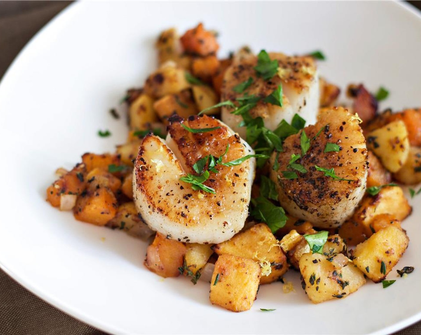 step 9 Divide the succotash amongst the plates, and place the scallops on top. Garnish with Fresh Chives (to taste) and some Lemon Zest. Enjoy!