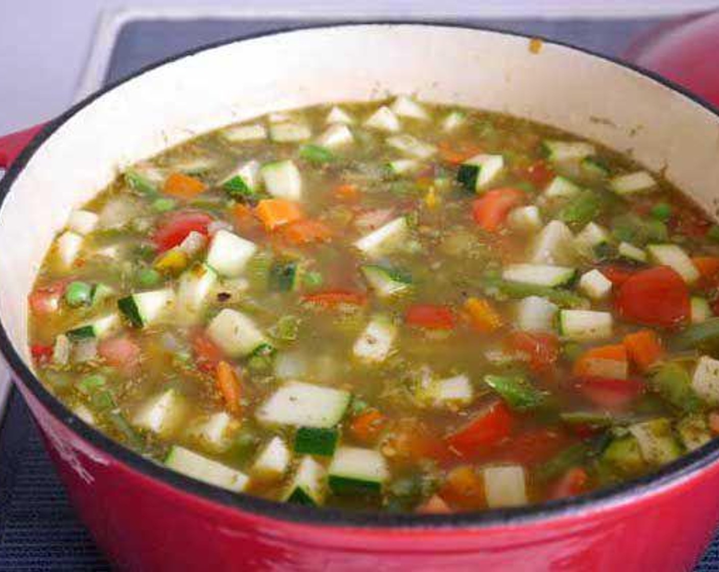 step 2 After adding the Zucchini (1), Potatoes (3), Vegetable Stock (8 1/3 cups), Dried Rosemary (1 tsp), Parmesan Cheese (to taste), and Tomatoes (2), stir and leave to cook for 20 minutes approx. Season with Salt (to taste) and Ground Black Pepper (to taste). After this add the Bay Leaves (2), Green Beans (1 cup), and Frozen Green Peas (1 cup). stir and continue to cook until the carrots are soft.