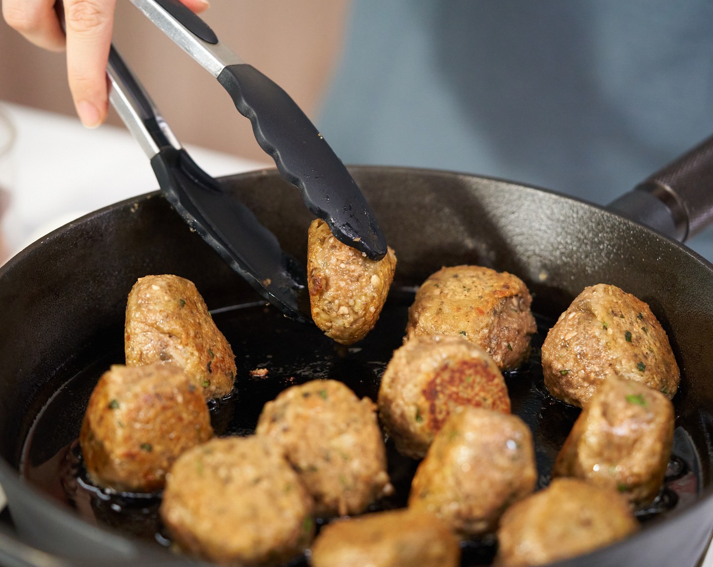 step 8 In a cast-iron skillet, heat the Vegetable Oil (1 Tbsp) over medium heat. Once hot, cook the meatballs for about 2 minutes on all sides. Cook in batches if needed.