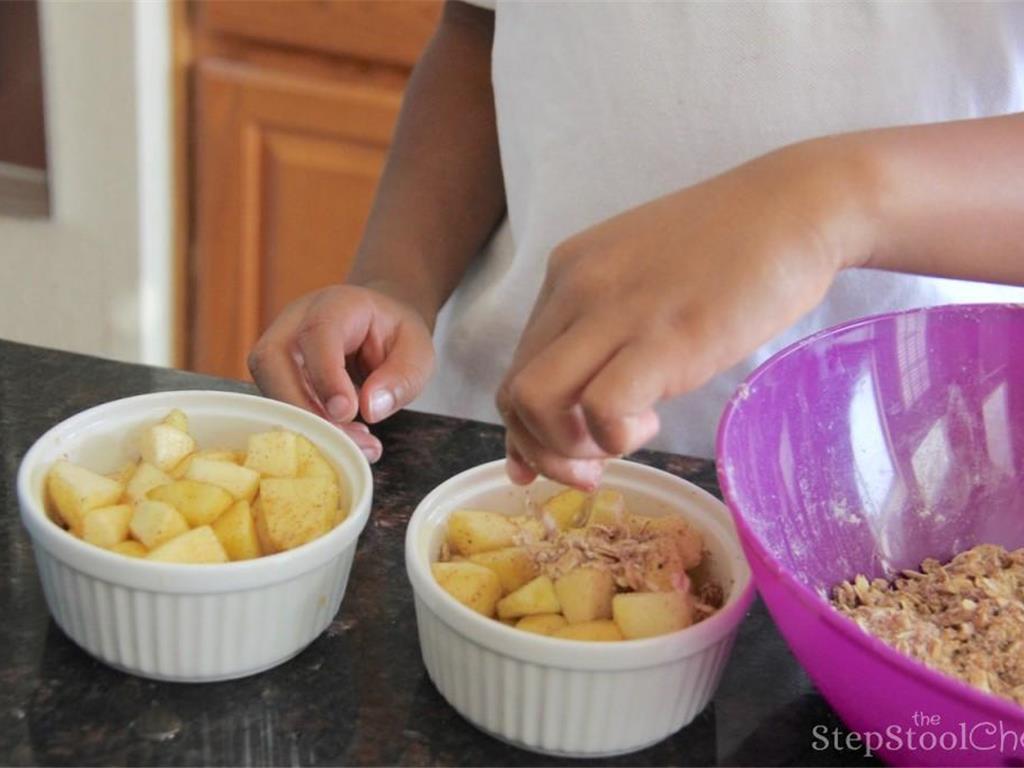 Step 6 of Yummy Dutch Apple Crisps Recipe: Lightly grease ramekin cups or baking dish with cooking spray. Place the filling into the ramekin cups or baking dish then sprinkle topping over filling.