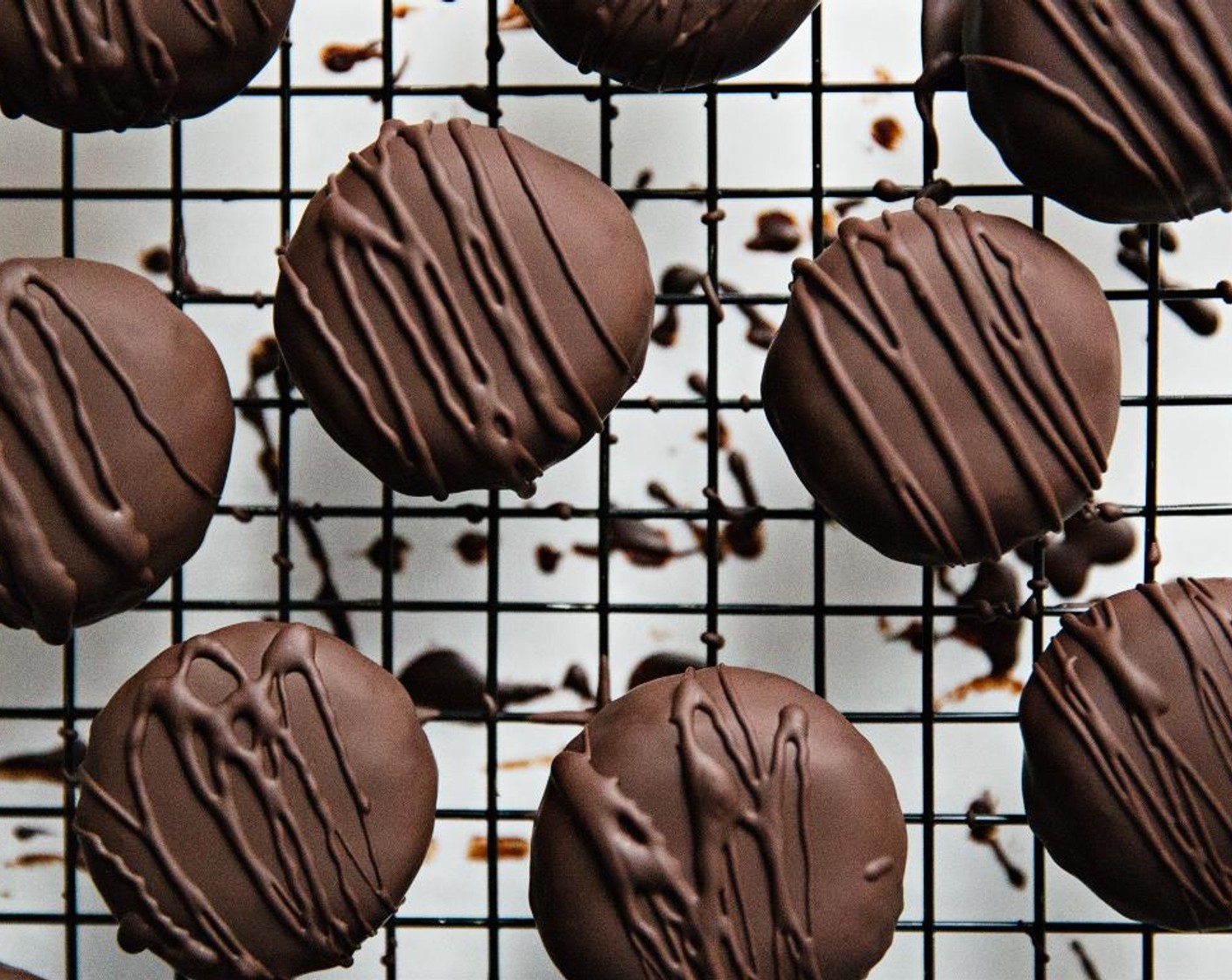 step 7 Using a fork, dip the patties into the melted dark chocolate. Tap off any excess chocolate and place on a cooling rack. Place back in the refrigerator to harden.