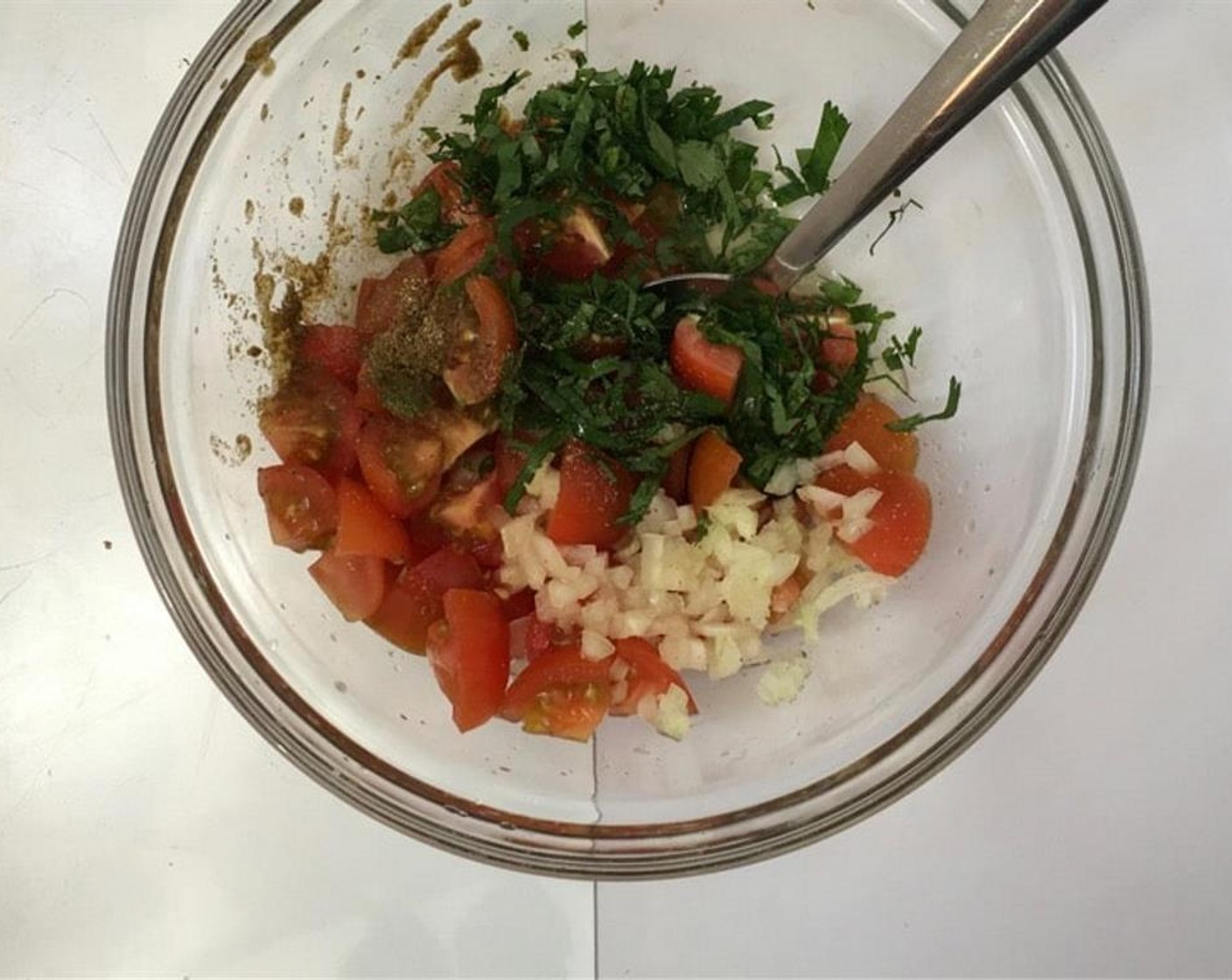 step 3 In a bowl, add Cherry Tomatoes (10), Onions (2 Tbsp), McCormick® Garlic Powder (to taste), Salt (to taste), Ground Black Pepper (to taste), Ground Cumin (1/4 tsp), juice from Lime (1), Fresh Cilantro (1 handful), and Fresh Mint (1/2 handful). Stir well and place the mixture in the fridge to chill.