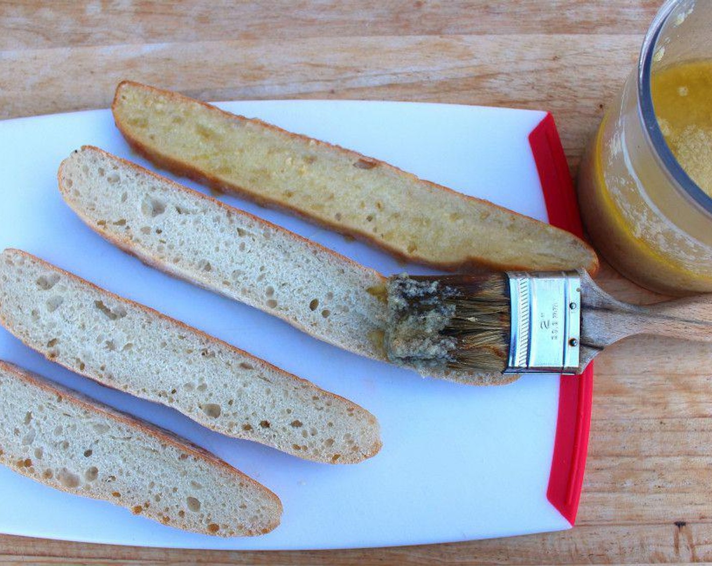 step 1 Brush Focaccia Bread (to taste) with Garlic Paste (to taste).