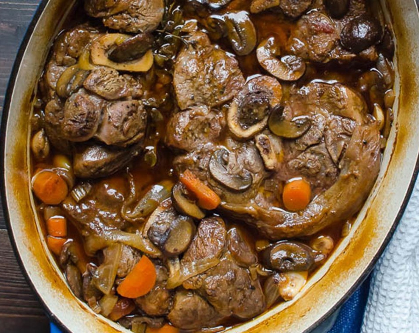 step 13 Add the vegetables and the herbs to the pot. Transfer the veal shanks to the pot, arranging them snugly into the broth with the vegetables. Add any accumulated juices from the plate.