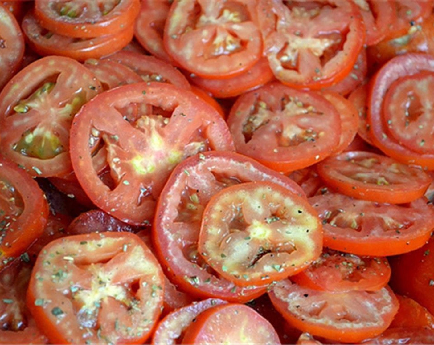 step 3 Put sliced tomatoes on a baking sheet. Add Salt (to taste), Ground Black Pepper (to taste), Granulated Sugar (1/2 Tbsp), Olive Oil (1 Tbsp), Dried Oregano (1 tsp). Toss it together till all tomato slices are evenly coated with oil.