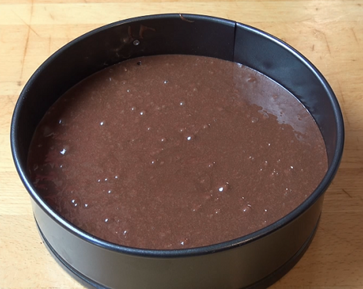 step 2 Lightly grease and line a 20-centimeter cake tin with baking paper. Carefully pour in the batter. Cook at 180 degrees C (350 degrees F) for 35-40 minutes or until cooked all the way through.