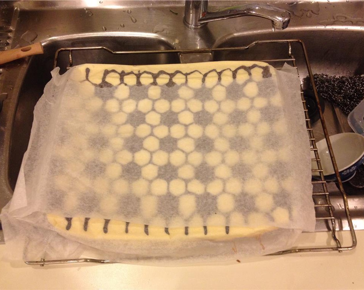 step 12 Once finished baking, place baking paper on top of the cake and flip it over to remove from the pan. Place the cake on a rack to cool down.