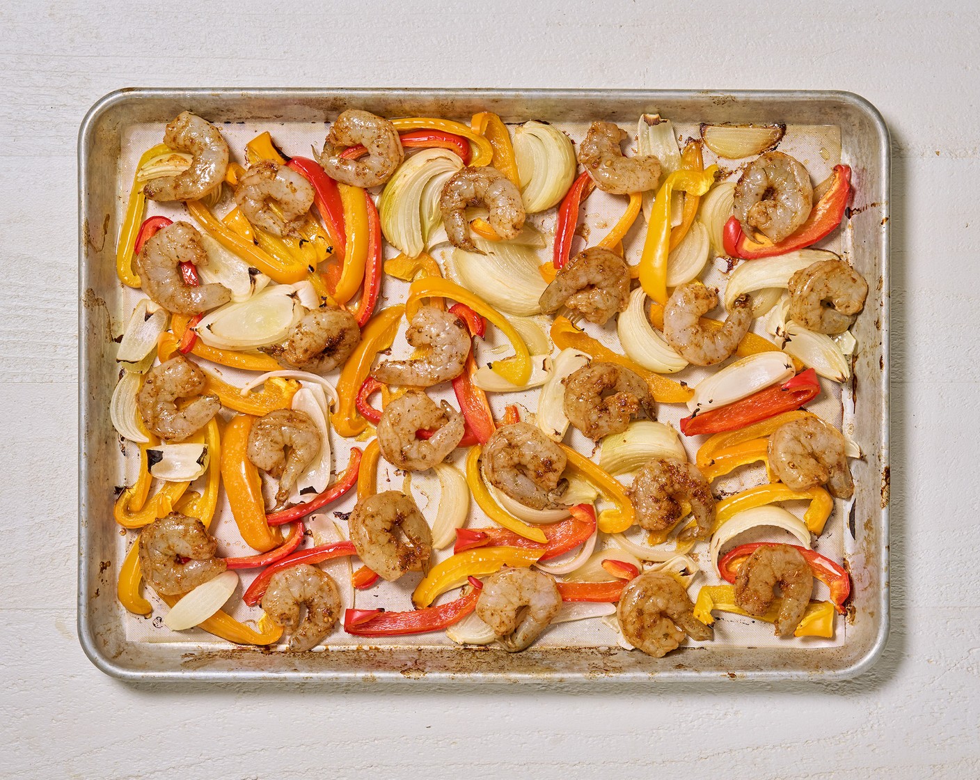 step 5 Add the seasoned shrimp to the same sheet pan, return to the oven and bake for 5 more minutes.