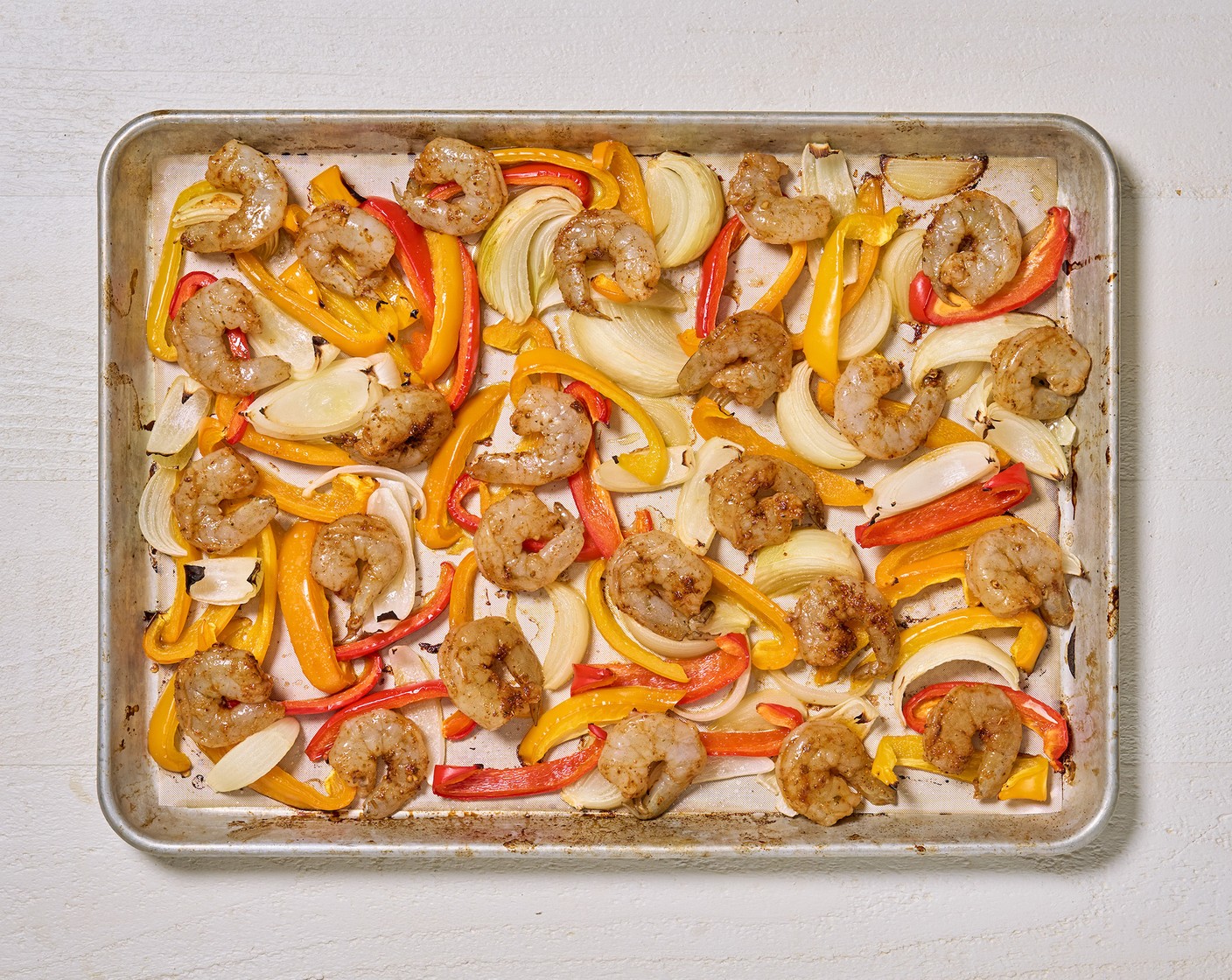 step 5 Add the seasoned shrimp to the same sheet pan, return to the oven and bake for 5 more minutes.