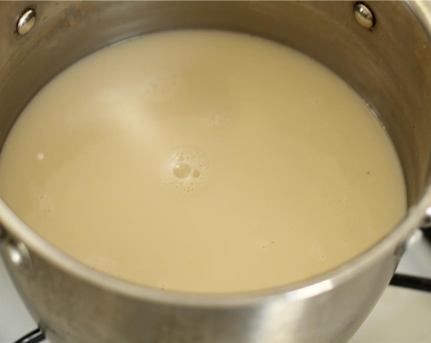 step 1 Combine Coconut Milk (2 cans) and Vegetable Broth (3 cups) in a large pot and bring to a boil.