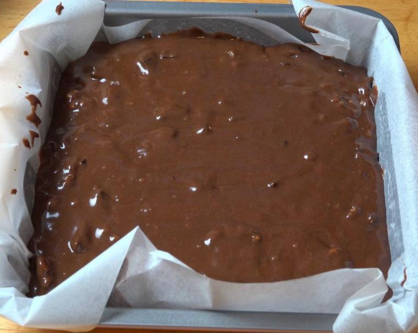step 5 Transfer brownie batter into a lightly greased 8-inch square cake pan lined with non-stick baking paper. Smooth the surface.