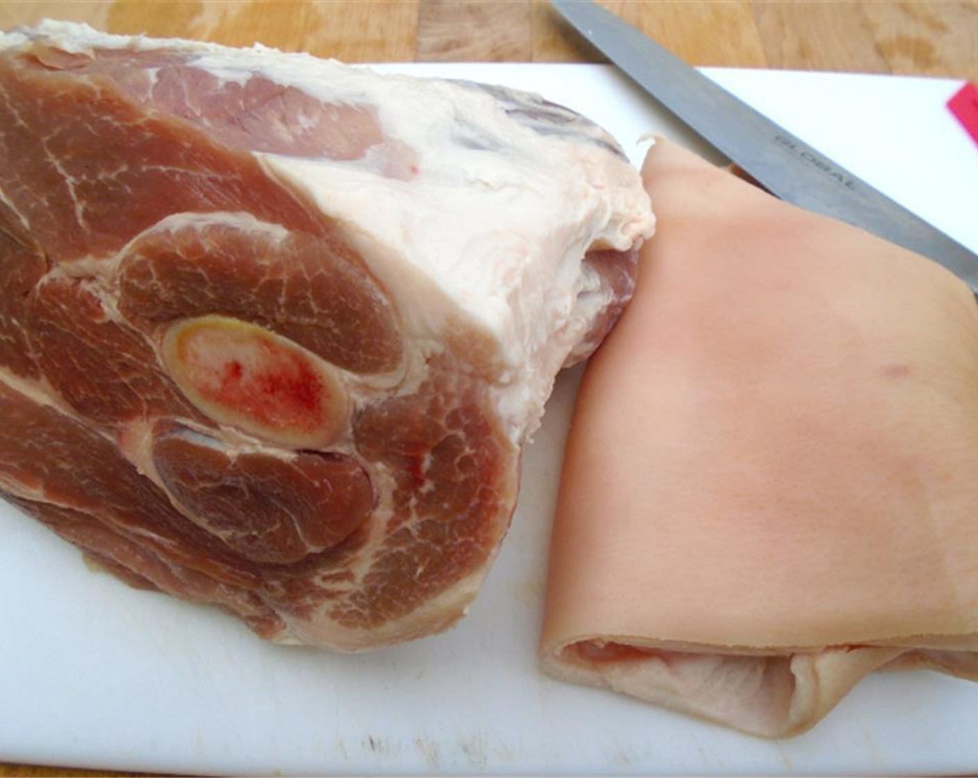 step 1 Remove the thick layer of skin from your Pork Shoulder (1).