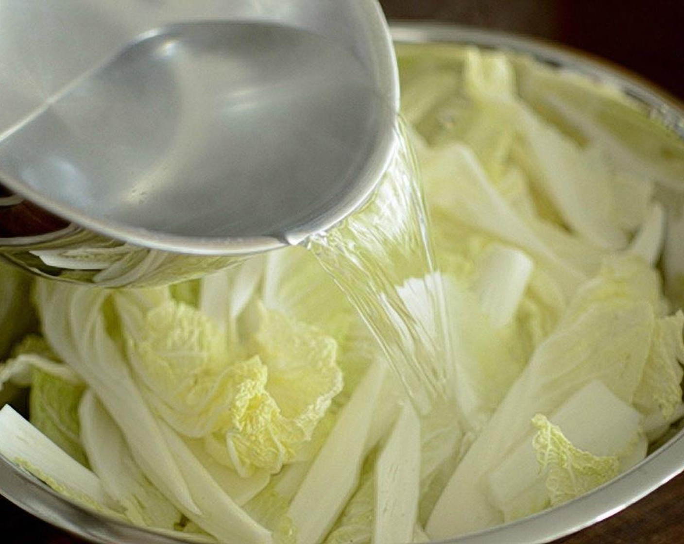 step 6 Pour the cooled water over the cabbage in the mixing bowl. Let it sit for 10 minutes.