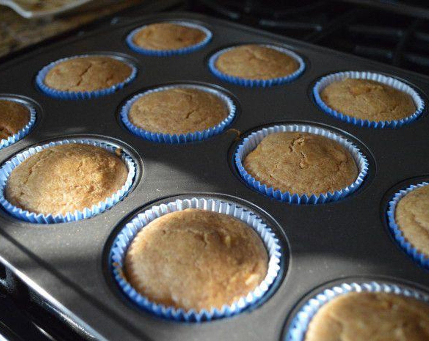 step 4 Use a 1/4 cup measure to scoop the batter into each lined muffin well. Get the muffin pans into the oven to bake for 20-25 minutes. Check that they are baked through with a toothpick. If inserted in the center of the muffin it should come out cleanly. Allow them to cool in the pan for a few minutes.