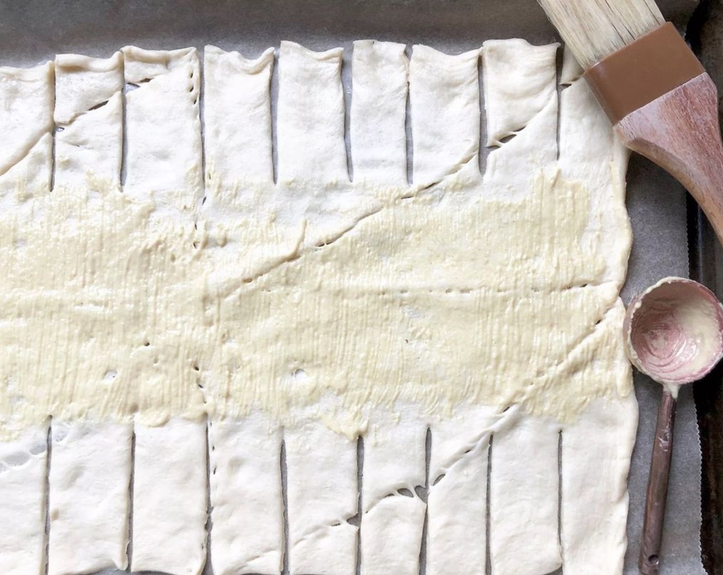 step 6 Spread the Dijon Mustard (1 Tbsp) evenly along the center of the dough with a pastry brush.