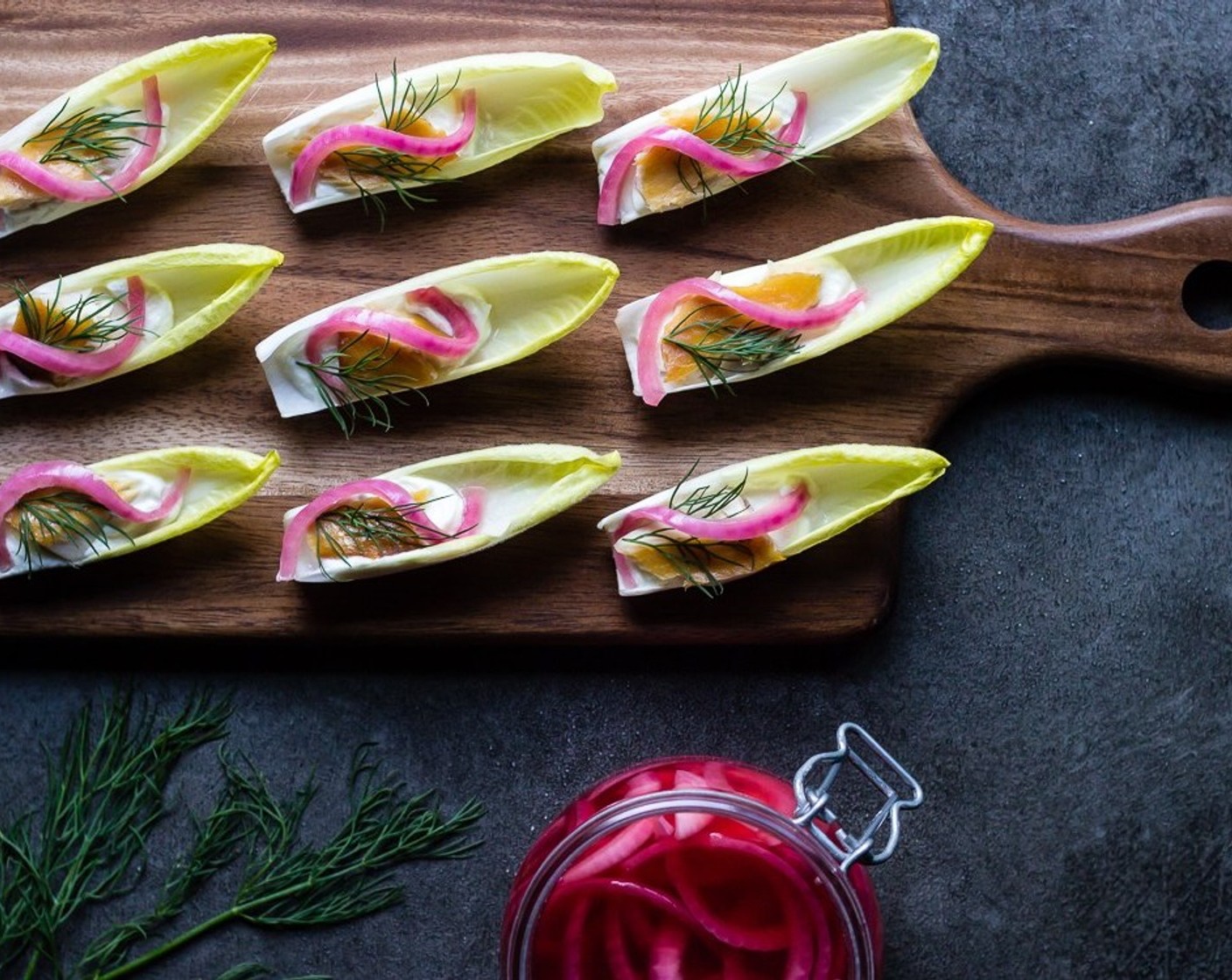 step 7 Take one slice of Pickled Red Onions (to taste) and garnish the top of each endive.