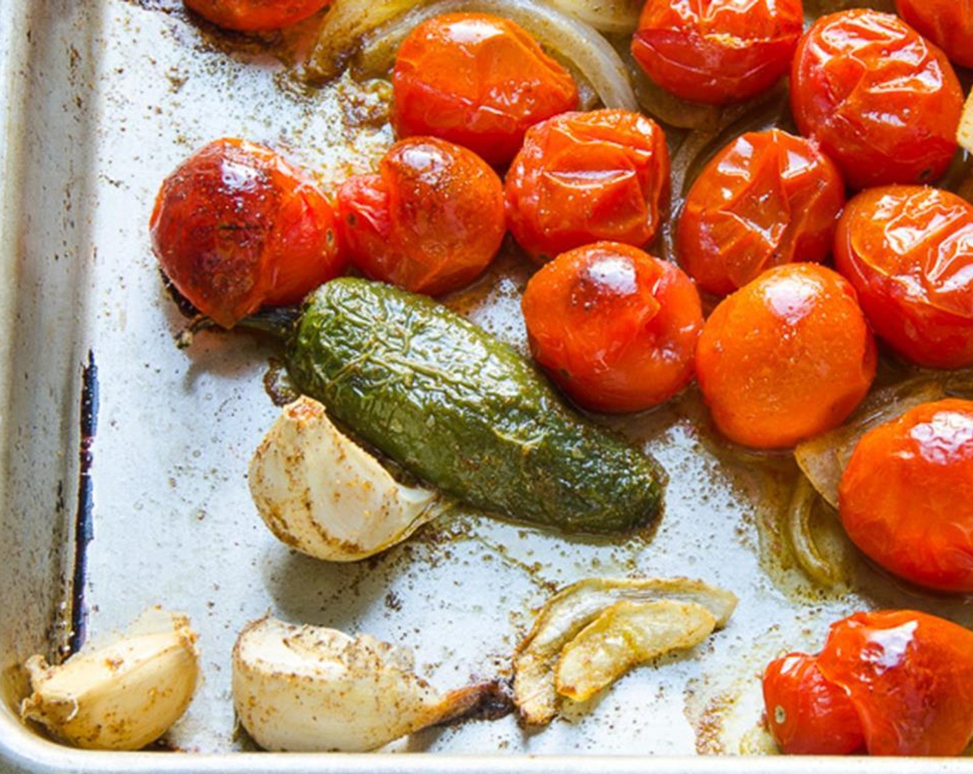 step 17 Place Olive Oil (3 Tbsp), Grape Tomatoes (2 cups), Jalapeño Pepper (1/2), chopped onion and Garlic (3 cloves) on a baking sheet. Sprinkle with Ground Cumin (1 Tbsp), Smoked Paprika (1/2 tsp) and Kosher Salt (1/4 tsp). Toss to coat. Roast vegetables for 20 to 25 minutes.