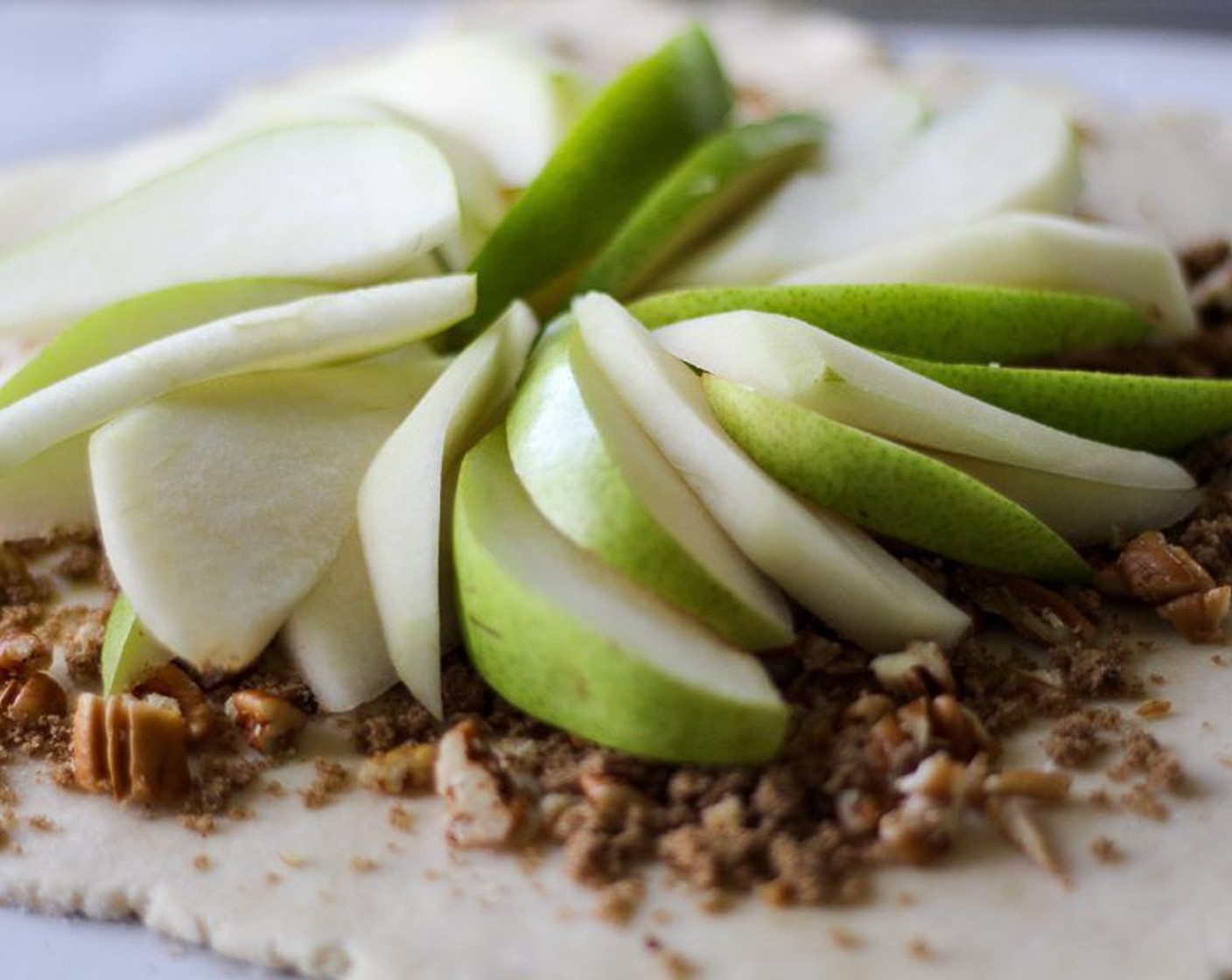 step 9 Arrange pear slices on dough. Fold edges of crust onto itself and the fruit.