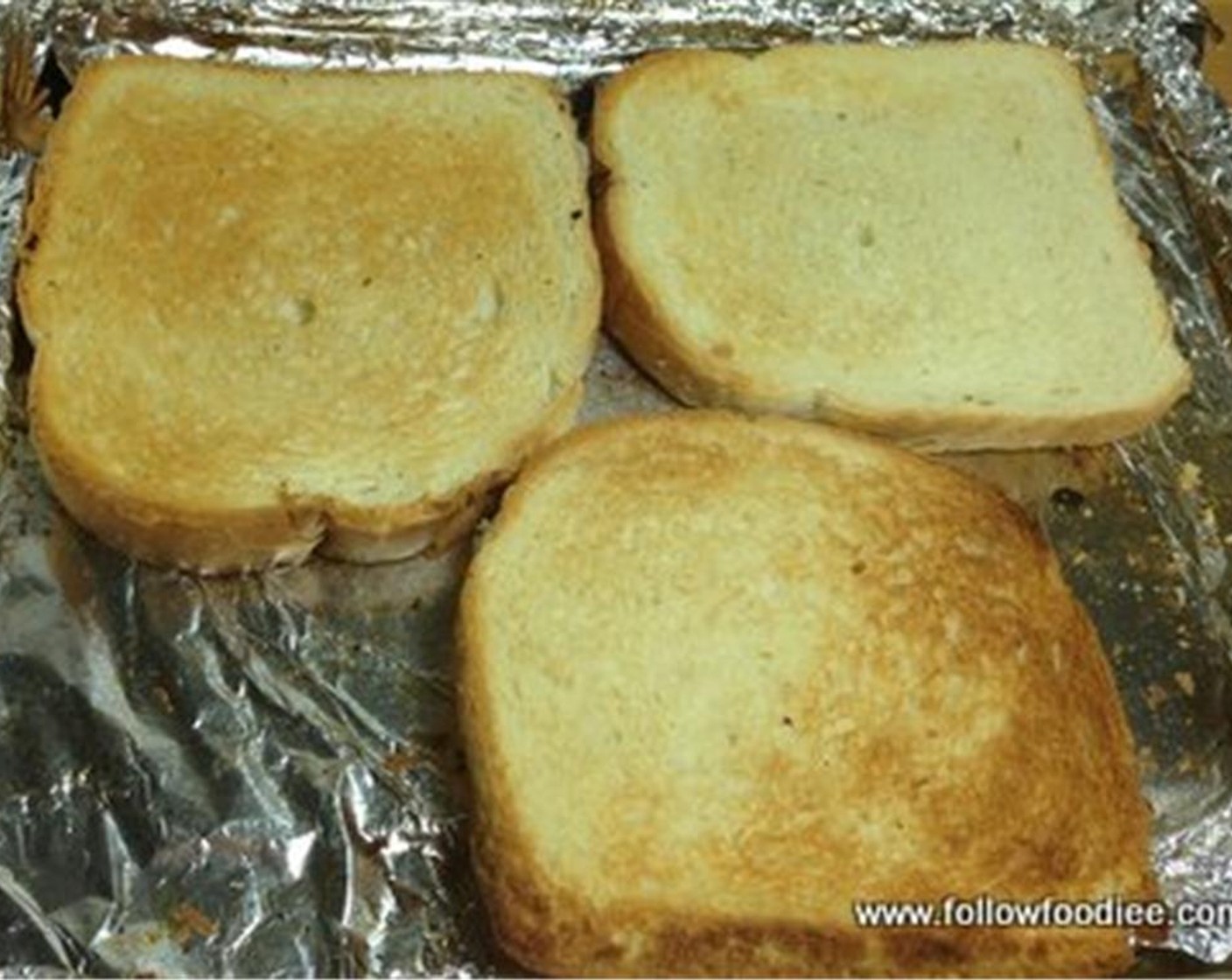 step 2 Place the Bread (3 slices) on a baking tray and toast the bread for few minutes, until brown in color.