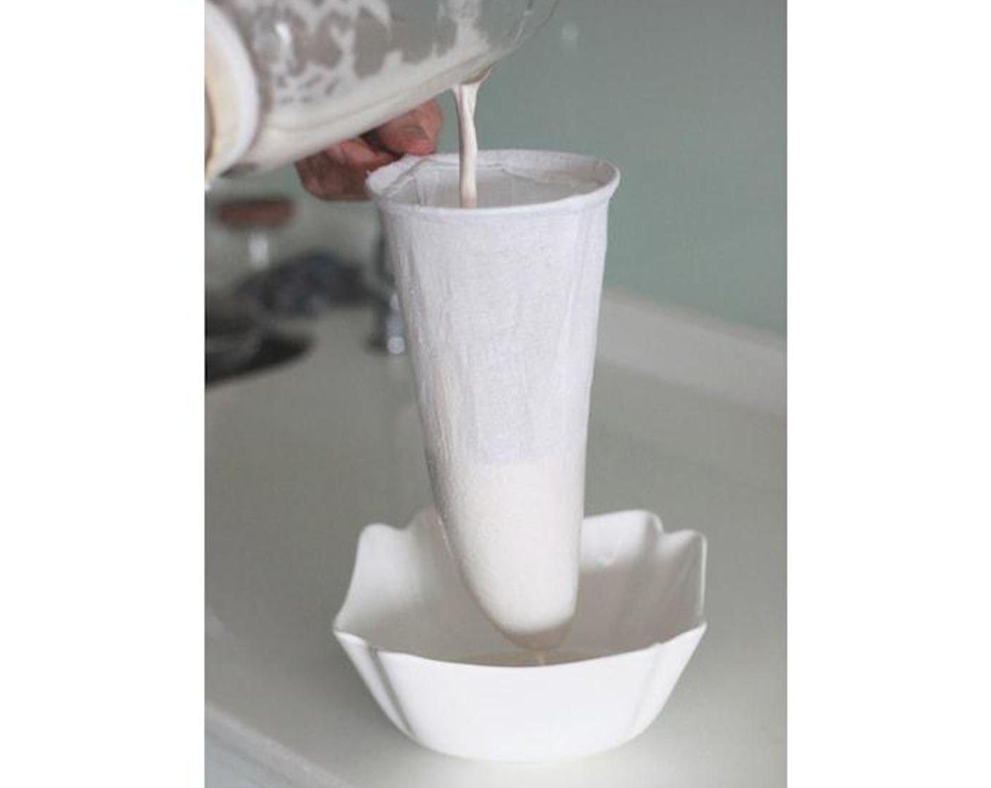 step 3 Place the tea bag over a large bowl and slowly pour the almond milk mixture into the bag.