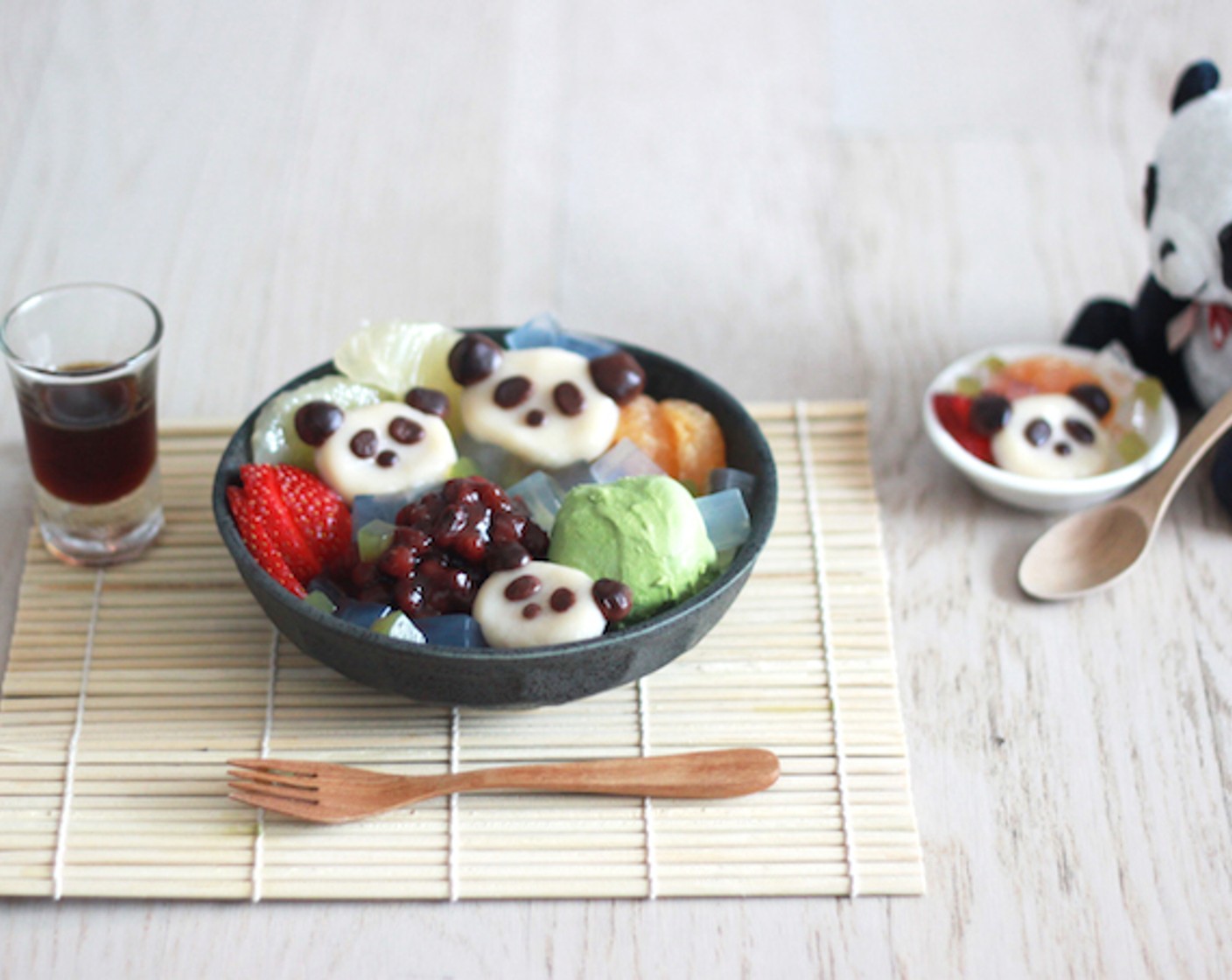 step 12 Decorate with Ice Cream (1 scoop), Fresh Strawberries (3), 3 orange wedges, and Red Bean Paste (3 Tbsp) to finish. Set kuromitsu on a side of the plate and you’re DONE! Now you’ve made a beautiful Panda Shiratama Anmitsu!